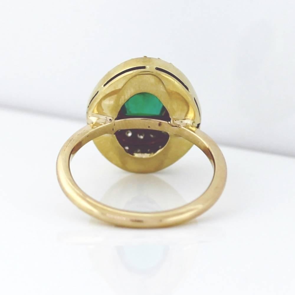 Magnificent oval shape natural green emerald!   The emerald weighs approximately 1.50 carats.  This 1970s style ring is made in 18k yellow gold and contains approximately .50ctw of white diamonds in the G-H color, Vs-Si clarity range. 

The ring