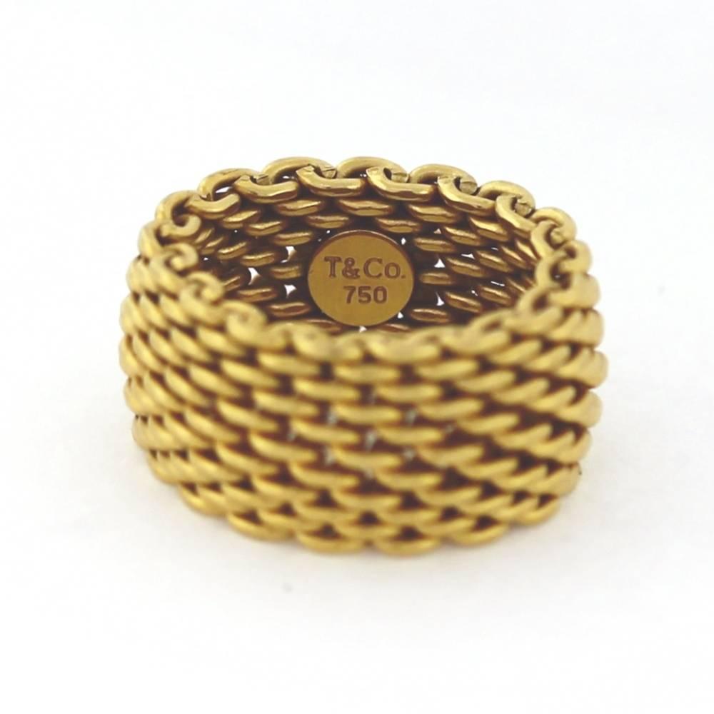 Classic Tiffany & Co Mesh band ring measures size 4.5 on the mandrel, but fits more like a size 4.5-5.5 because it flexes.  Stamped T&Co and 750(18K Gold)