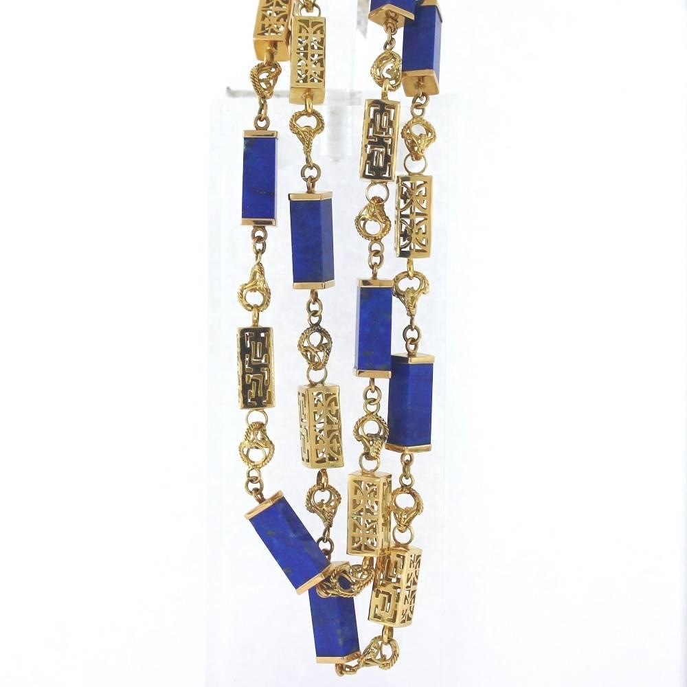 A fabulous necklace! Crafted from 14k yellow gold featuring a unique multi ring circular chain along with 10 rectangular lapis links. Weighs 75.80 grams, 31.5 length chain that fastens securely with a locking clasp.

