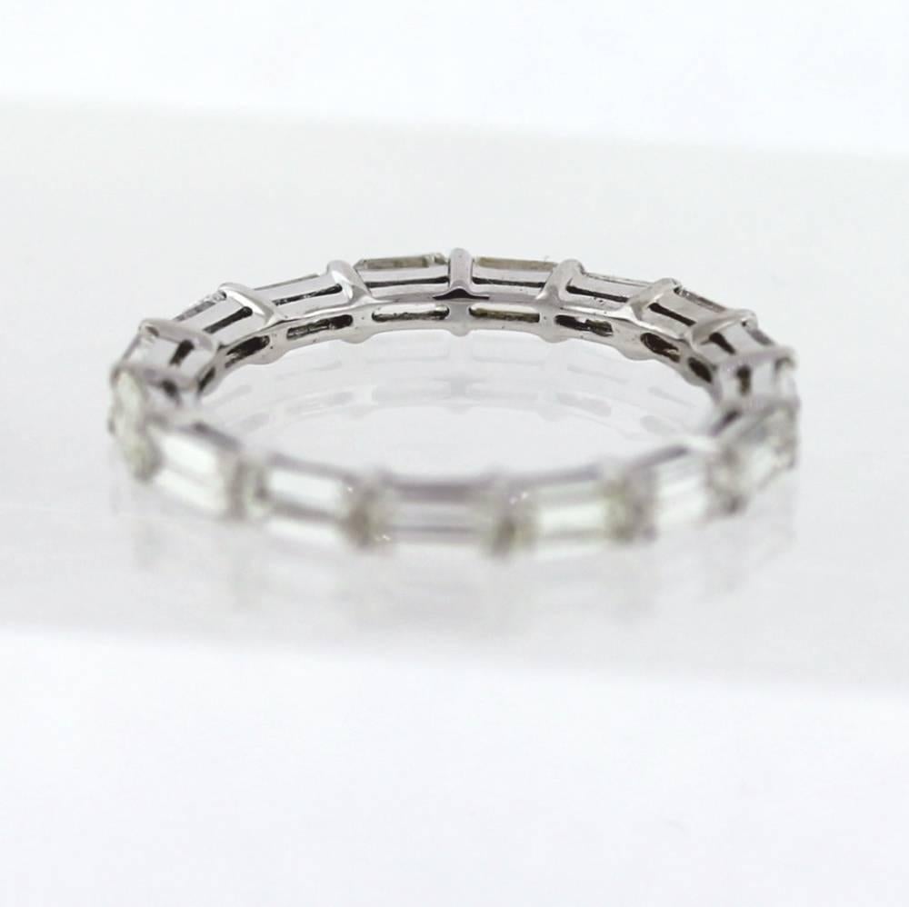 Hand Finished Eternity Band made in Platinum.  The band contains 17 Emerald Cut diamonds that layout 