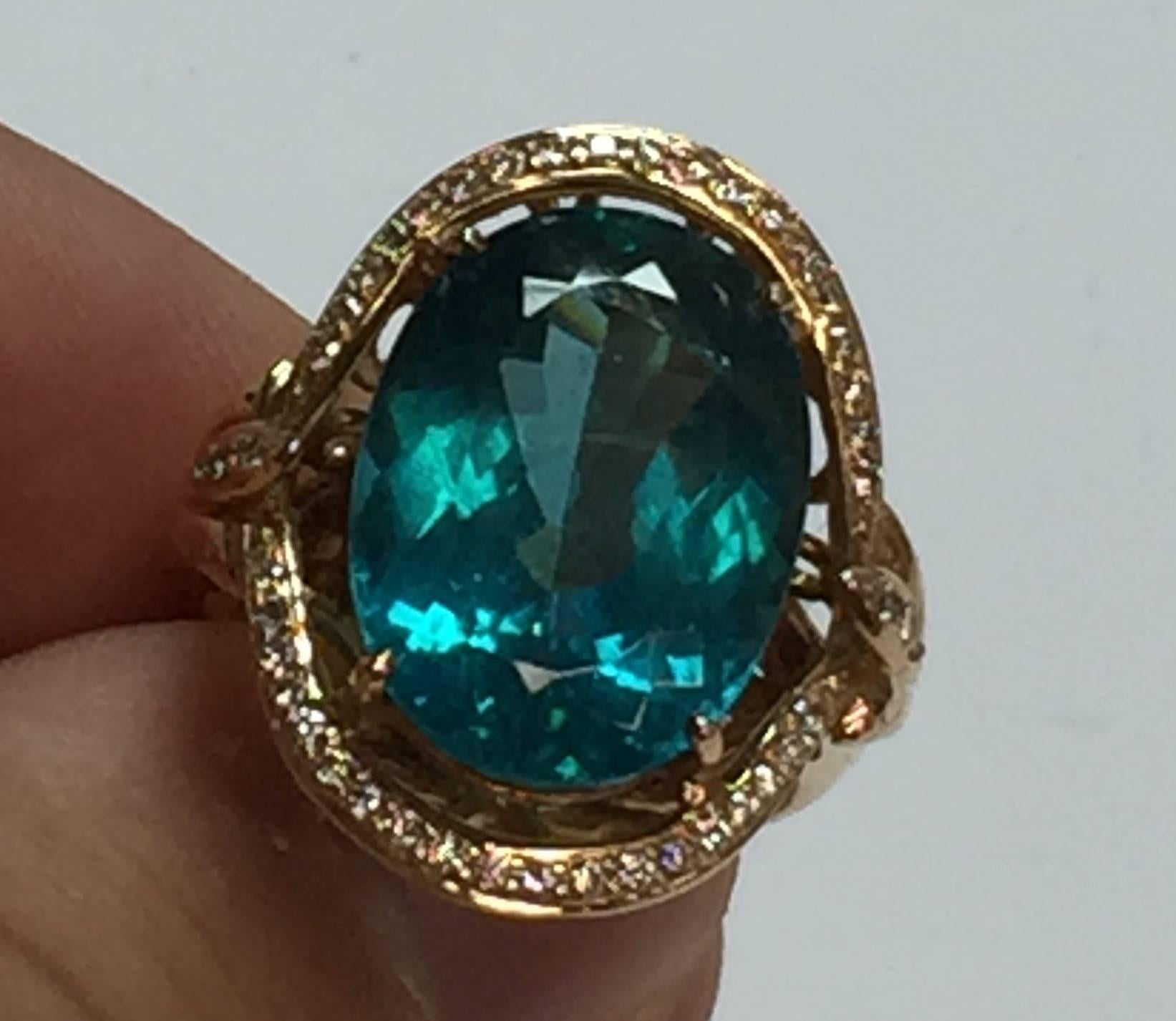 Beautifully colored Apatite ring in 18k Rose Gold with 44 diamonds weighing a total of about .30cts.  The center stone features a 13.61 carat Apatite.  The ring has very well made wire work in rose gold.  