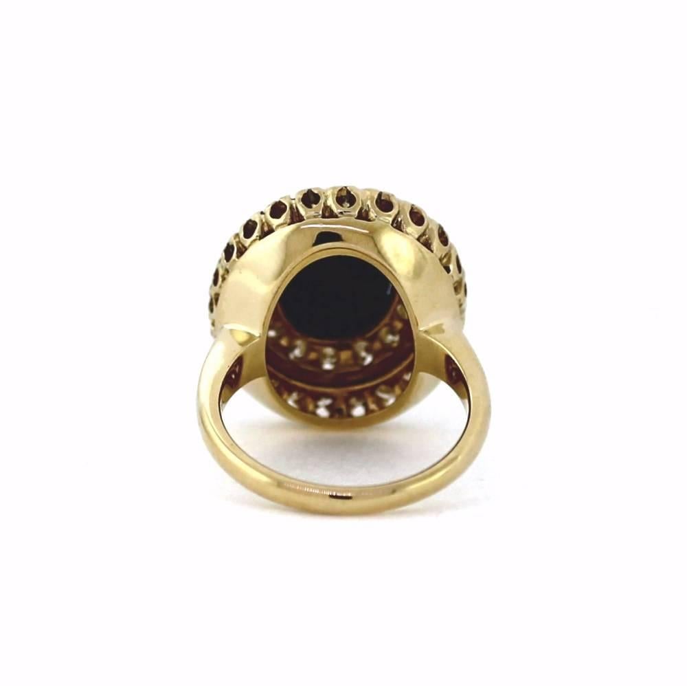 A rare and unique black star sapphire center stone featured in this ring.  The color of this cabachon shaped sapphire is black with a phenomenon called asterism.  As you tilt the ring, two sharp lines intersect to create a star.  The sapphire is