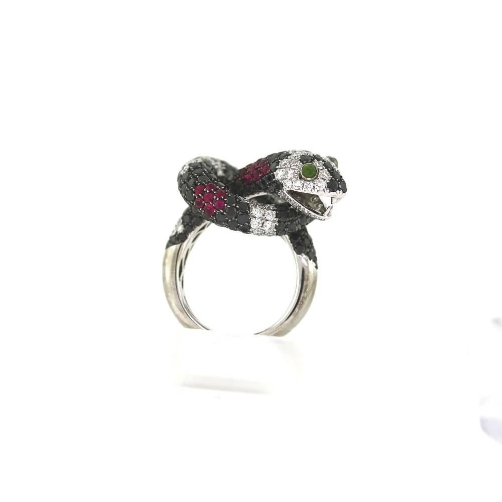 Wow!  Extremely neat and well made ring.  Snake shaped diamond ring feauturing two green garnet eyes!  The ring consists of approximately 222 black diamonds weighing a total of 4.53 carats.  Approximately 108 round white diamonds weighing 2.12
