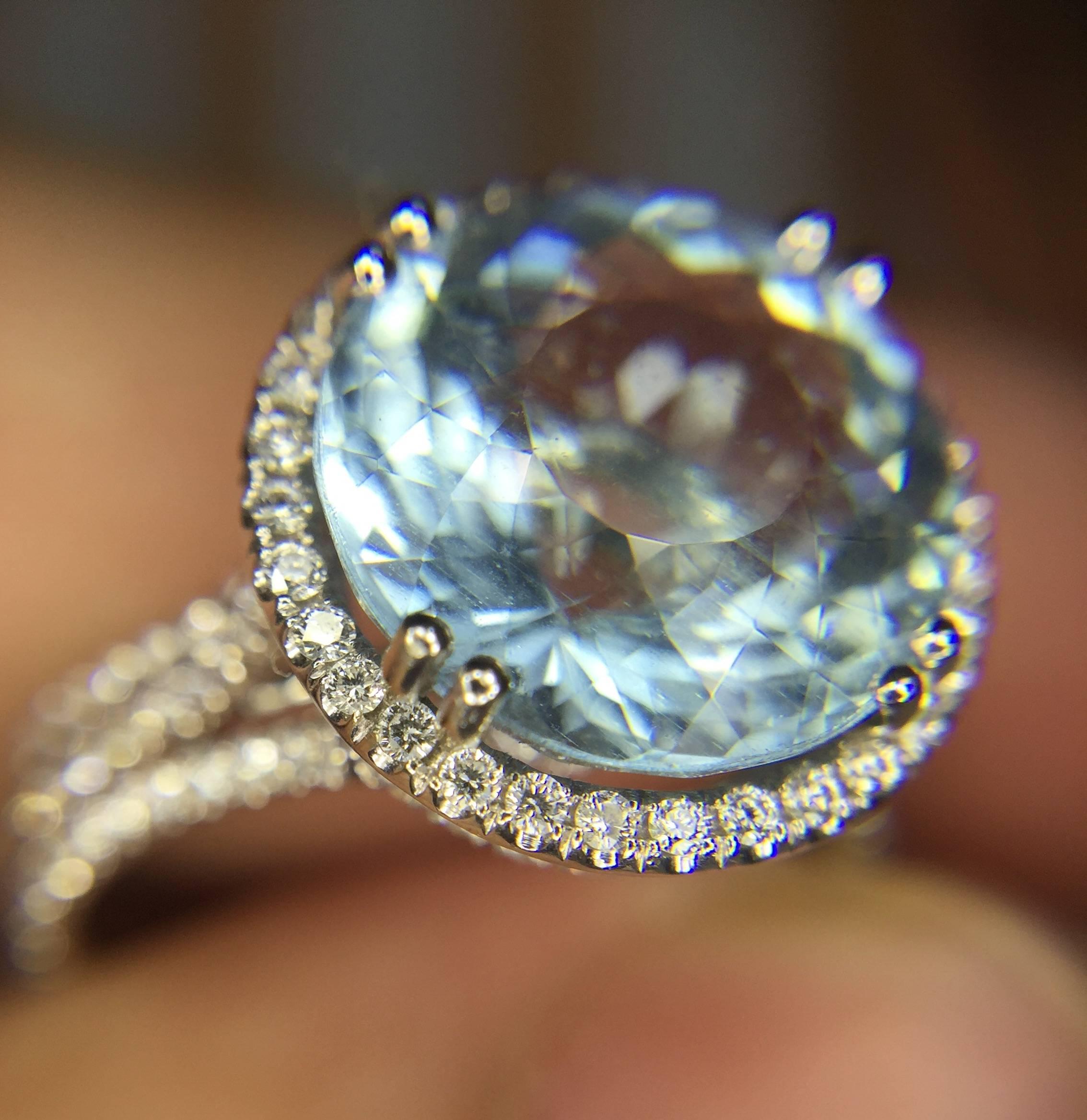 Magnificent Aquamarine ring... The ring is made of 18k white gold and features this absolute beauty of a round, finely cut, aquamarine weighing 4.39ctw.  The aquamarine has rare, beautiful color to it.  It is surrounded by approximately 146 round