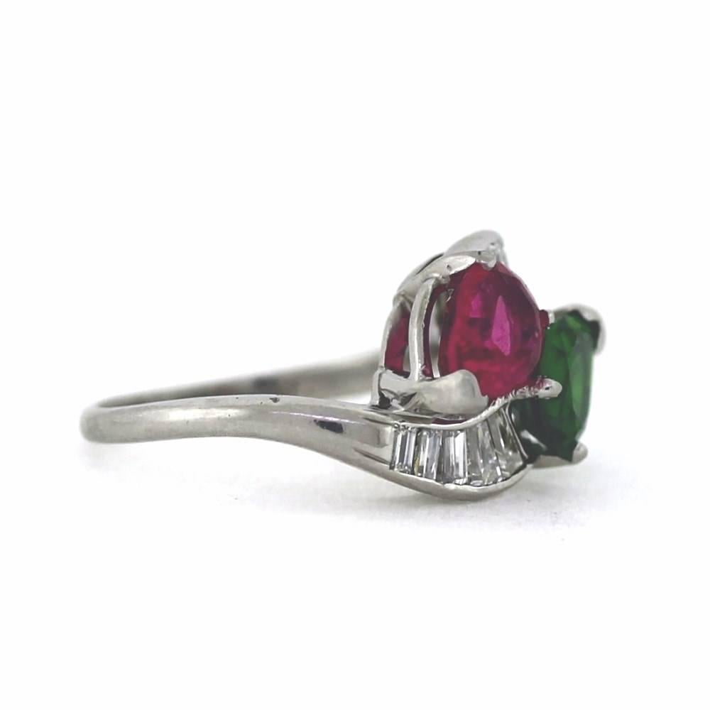 This ring is classic and right now, 2 stone rings are hot!

2 Green & Pink Pear shape Tourmalines weigh 3.00tcw wtih 10 tapered baguettes totalling .70tcw.  Size 6.5, sizable.

