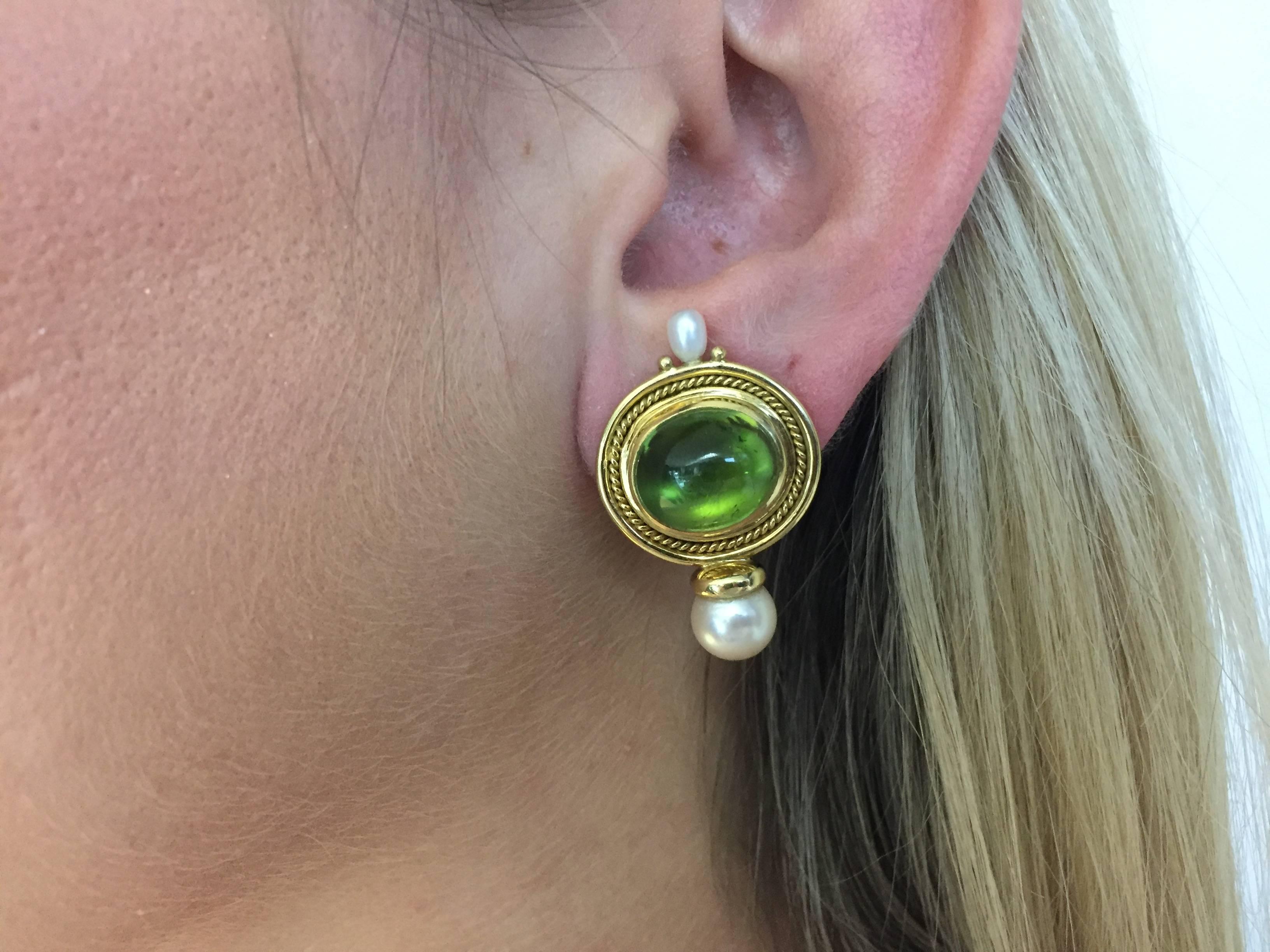 Easy to wear Beautiful Elizabeth Gage Earrings... 18k Yellow Gold with Peridot Cabachon Cut Gem Stones featured in the center with 2 Pearls on each earring.

Elizabeth Gage is an award-winning British jewellery designer and trained master goldsmith