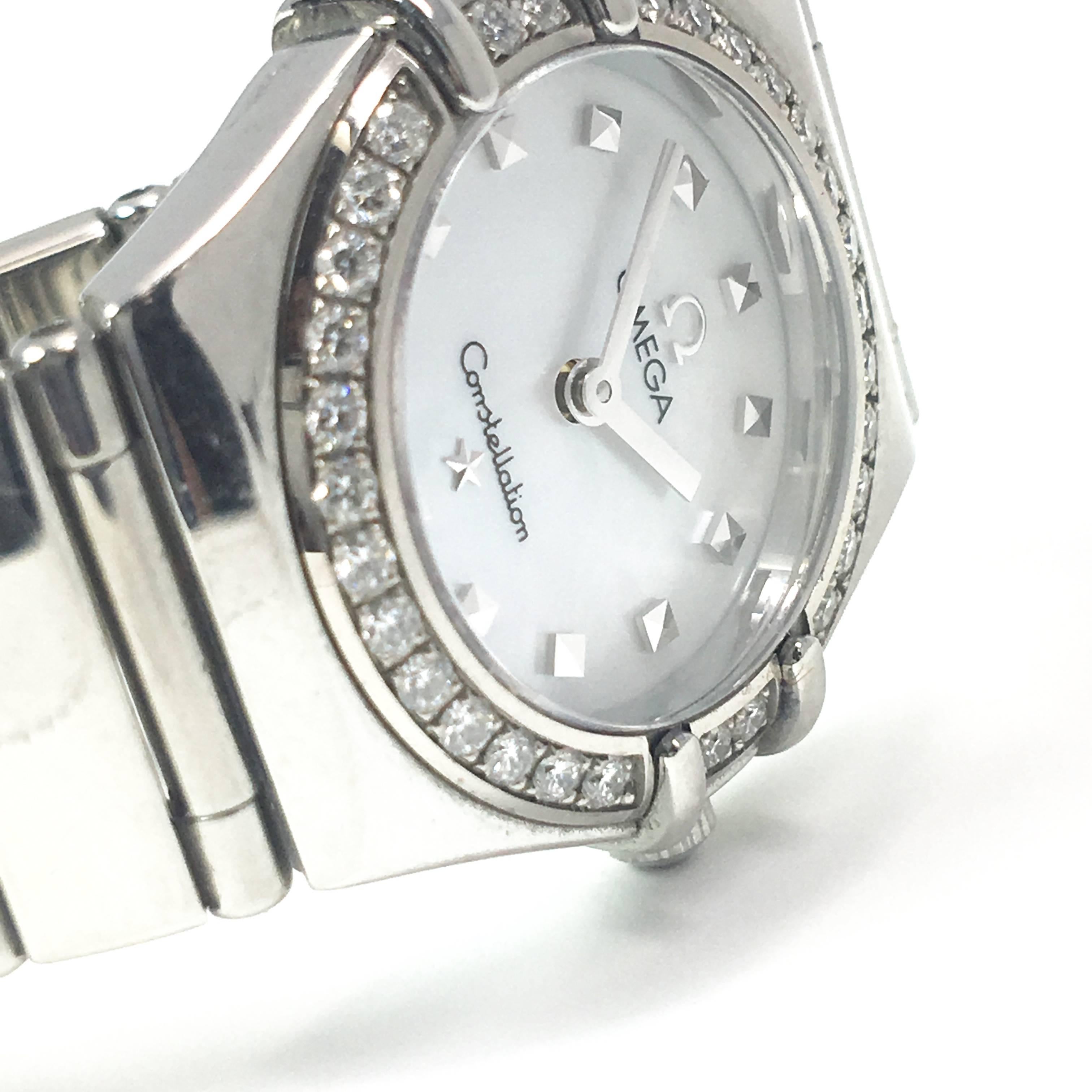 This ladies omega watch is made of stainless steel with a mother of pearl dial. The diamond bezel has approximately .33ctw of diamonds. Comes with box and papers. Model number 14657100.