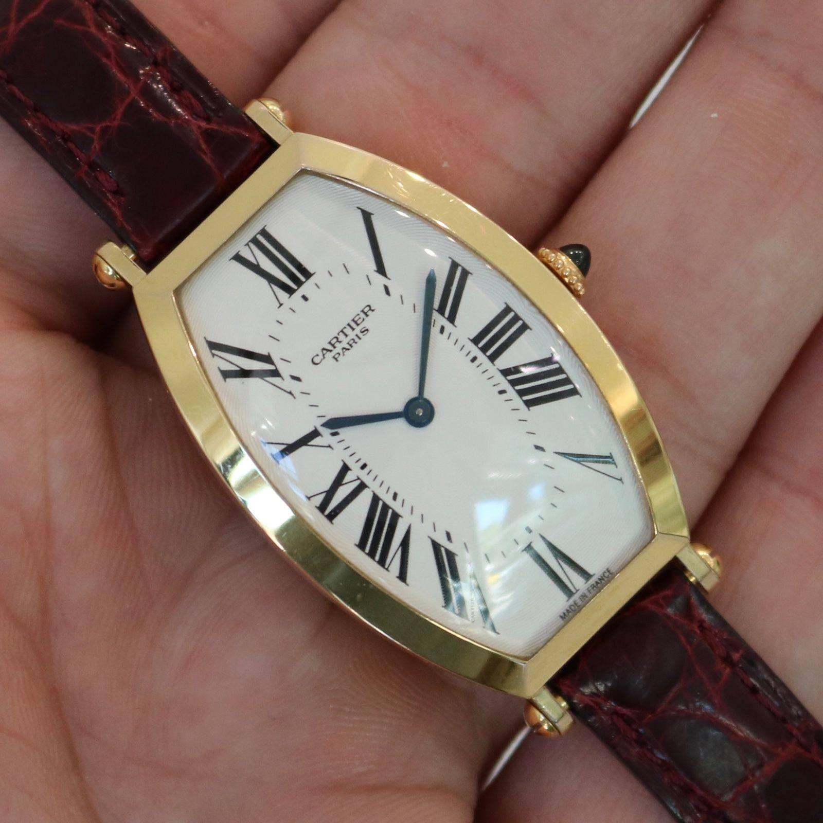 Brand Name:  Cartier
Style Number:  2458C
Series:  Tonneau "Privée Collection"
Gender:  Unisex
Case Material:  18k Yellow Gold
Dial Color:  Silver Guilloche
Movement:  Mechanical
Engine:  Cal. 78/1
Functions:  Hours, Minutes
Crystal