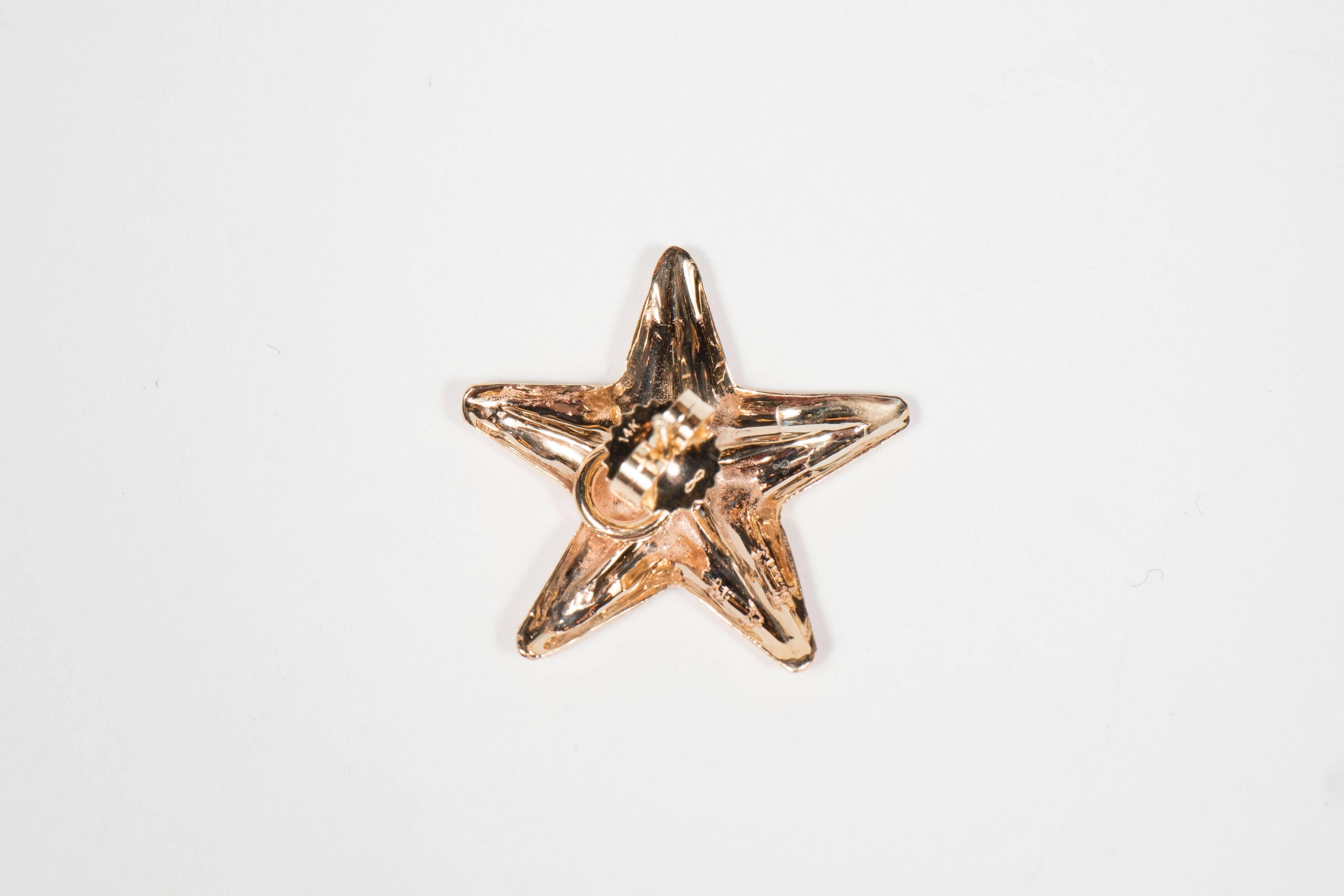 These 18k yellow gold earrings are designed as starfish and they are made by Seaman Shepps.They way 2 grams and bear the mark of Seaman Schepps.
