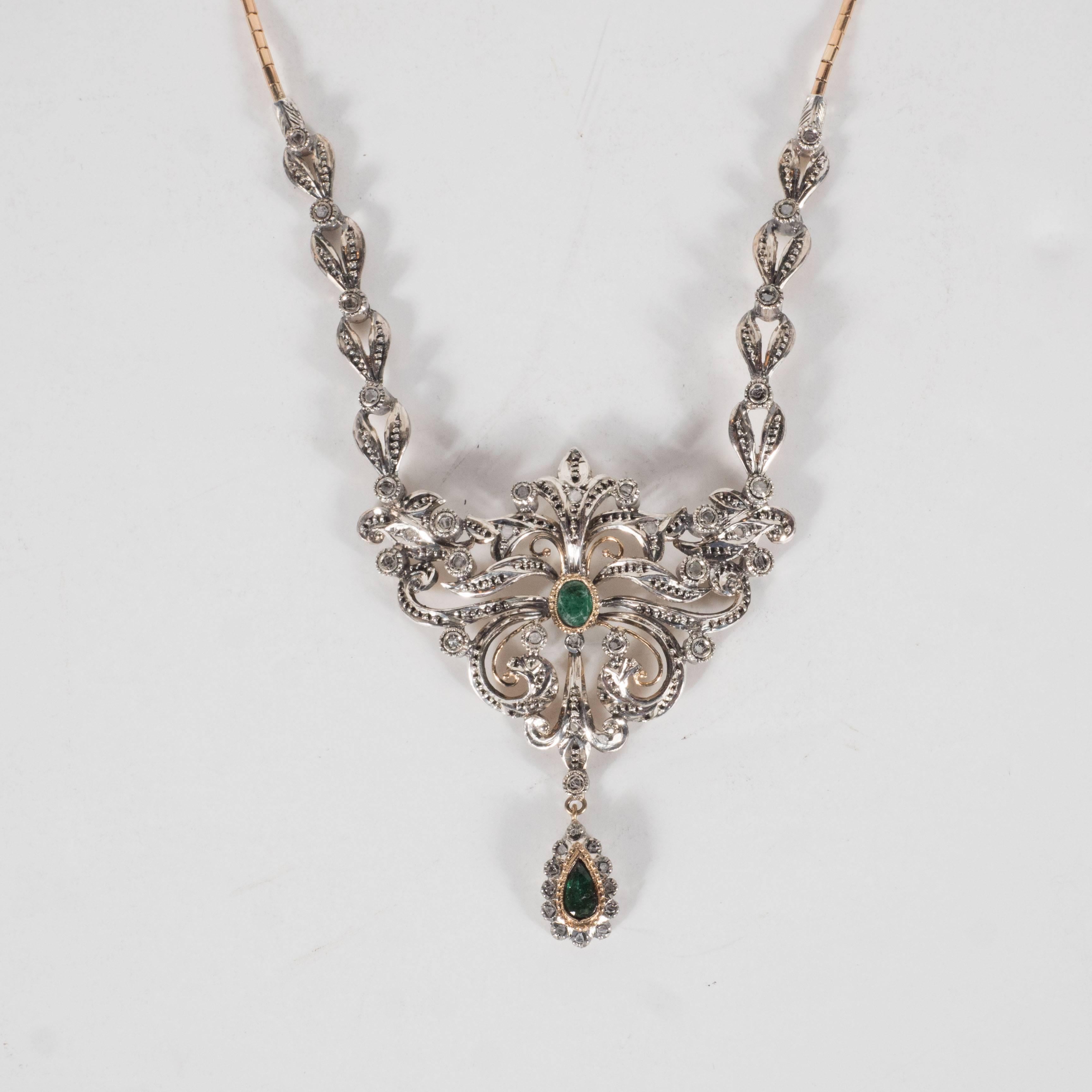 This Edwardian suite of Jewelry consists of a Necklace ,earrings, ring and bracelet . They are made of sterling silver and 18k yellow gold all set with diamonds and emeralds.They are of a stylized floral and foliate design.The necklace measures 16