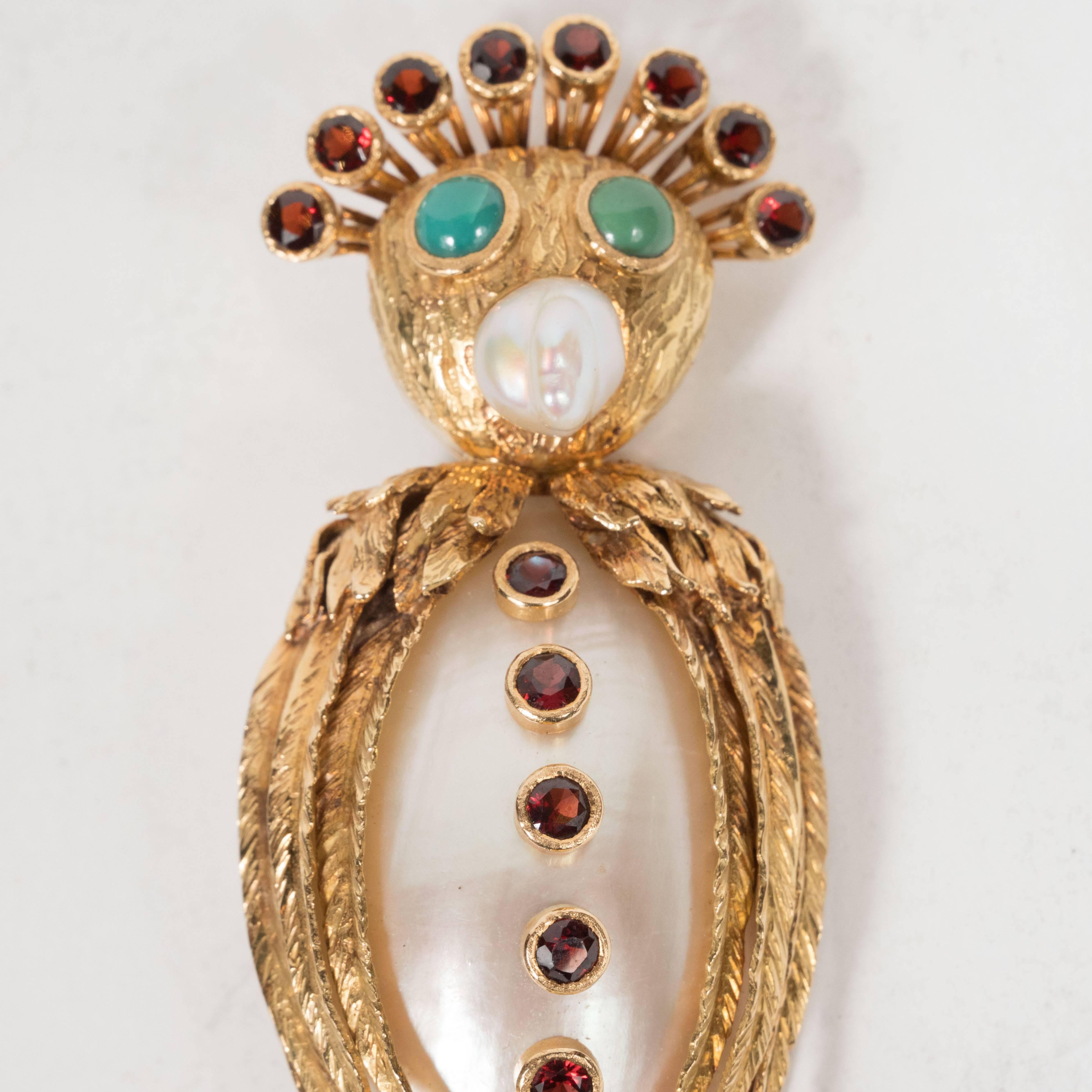 This dazzling and whimsical owl brooch features a nacreous mollusk body adorned with six campari hued garnet 