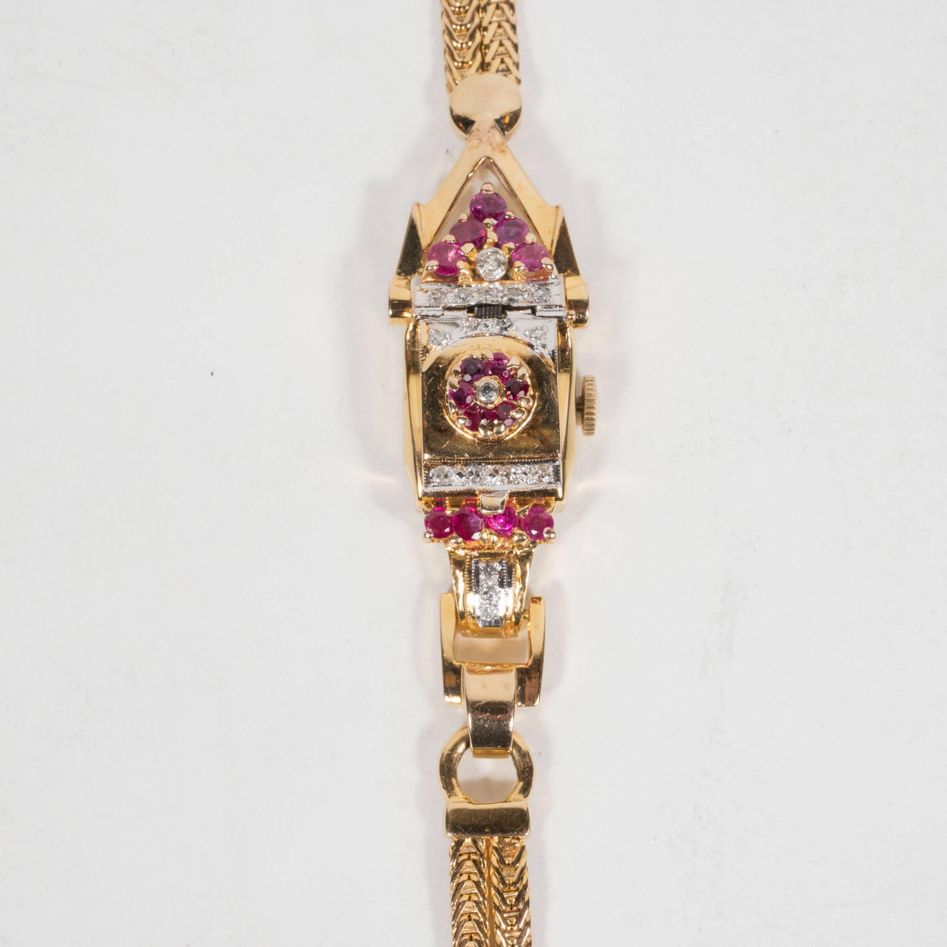 This elegant rose gold and platinum retro wrist watch by Lente features a full karat of rubies and a half karat of brilliant white diamonds. The face is covered by a gold flap with a tulip shaped ornament in the center composed of carnelian red