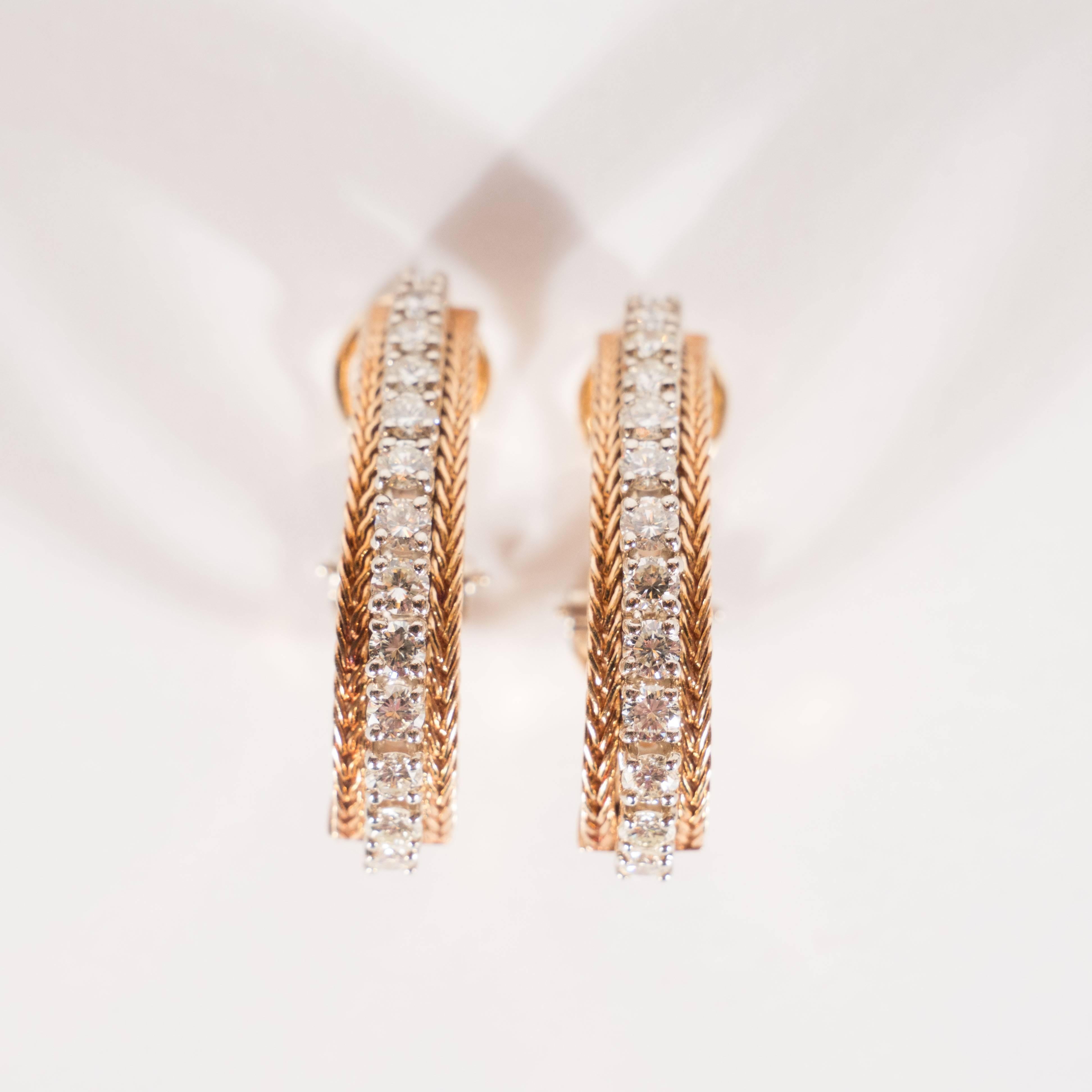 This stunning set of Mid Century Modern earrings offer approximately 1.80 carats of brilliant cut diamonds flanked on either side by a row of finely braided 14k yellow gold. The jewels are set in 14k white gold, which offers a subtle tonal contrast