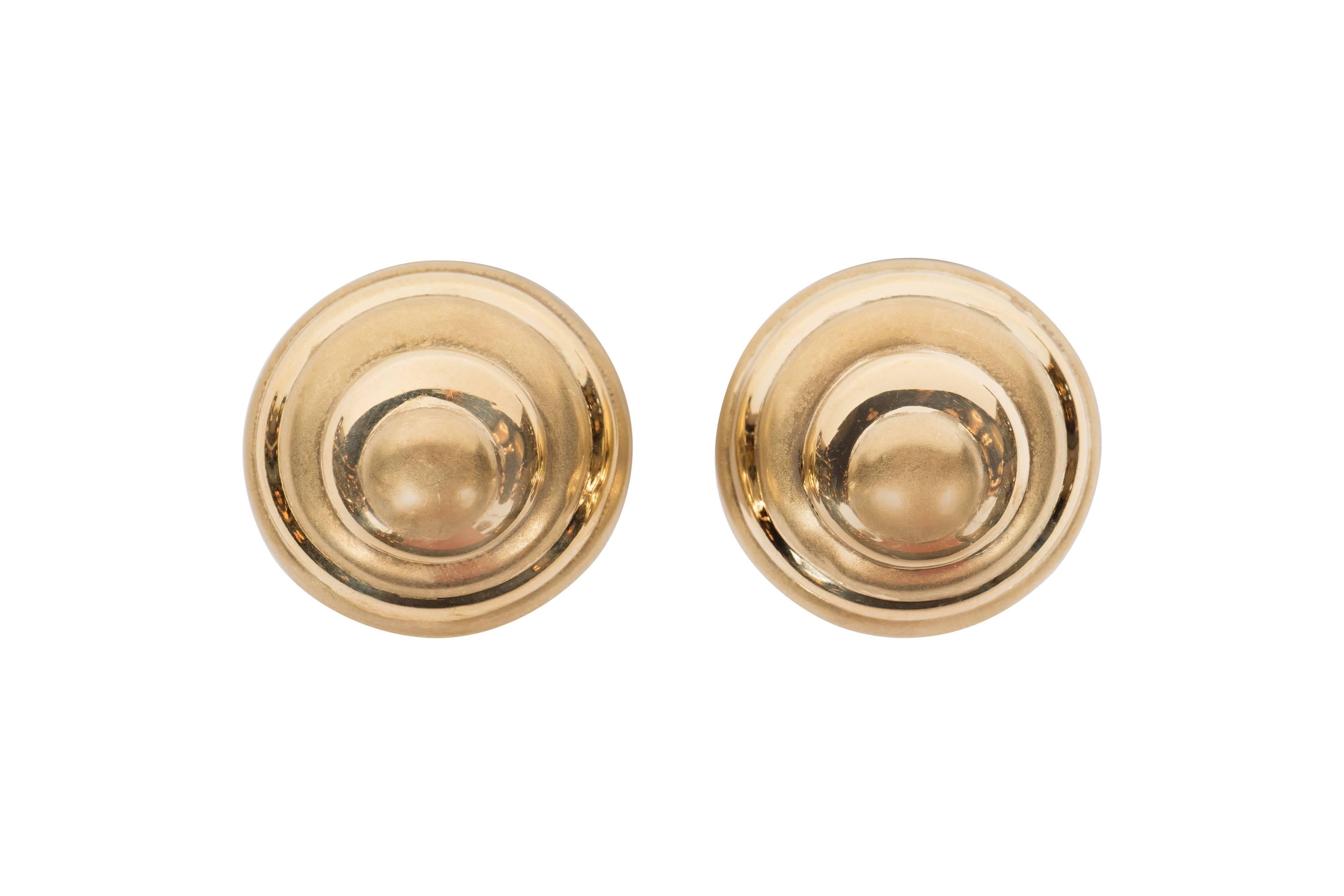 Realized in the United States circa 1968, these 18kt yellow gold earrings offer a stylized modernist shell design in swirls of brushed matte and radiant 18kt gold. They are marked 18k and are currently clip on earrings but the can be converted by