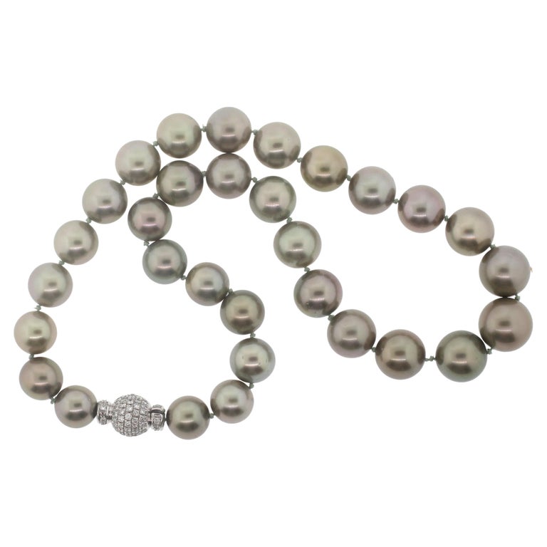 Hakimoto By Jewel Of Ocean Tahitian South Sea Strand Necklace
18K White Gold  1.7 Carts Full diamonds Clasp
Weight (g): 84.5
Cultured Tahitian South Sea Pearl 
Pearl Size: 14X11 mm 
Pearl Shape: Round 
Body color: Green
Orient: Very Good
Luster:
