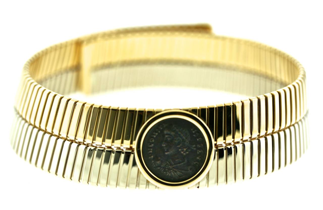 Bulgari 18k yellow and white tubogas choker centering an ancient coin. These wide coin chokers were infrequently made but highly prized components of the Monete Collection of the 1970s and 80s. The tension mechanism allows for a perfect fit and