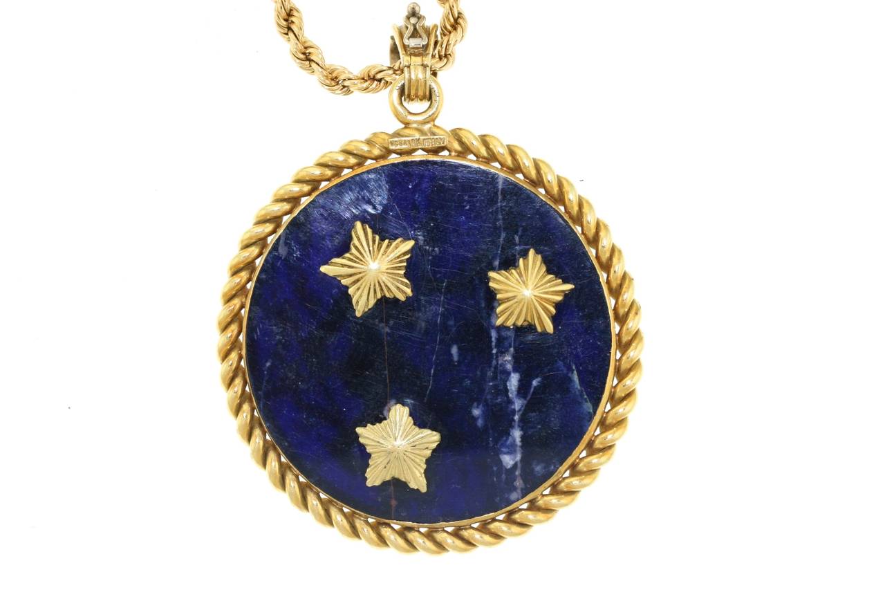 Van Cleef & Arpels 18k gold Gemini symbol mounted on lapis with a twisted gold frame and opening bale. Single diamond set in gold star on front of pendant. Measures 2.25