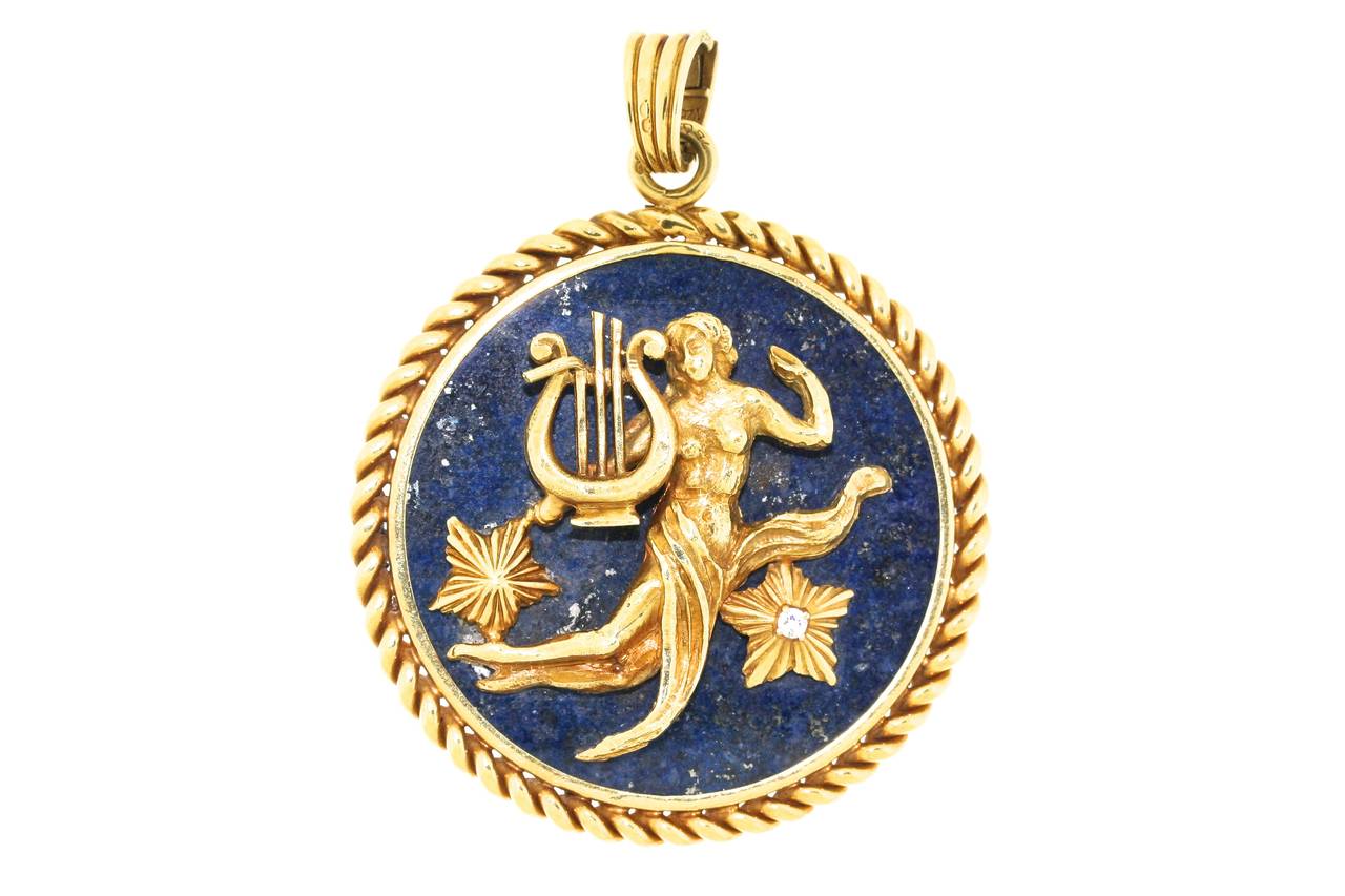 Van Cleef & Arpels Virgo zodiac pendant in 18k gold mounted on lapis with one diamond in the center a gold star. 2.25