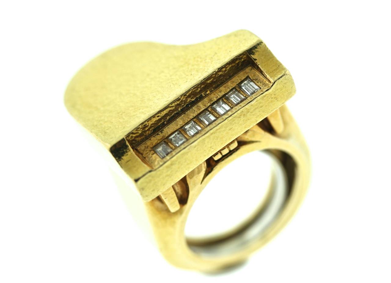 A unique David Webb 18k hammered gold ring of a piano motif with seven diamond keys. 1' diameter. Signed WEBB. Size 7.5 can easily be resized. Circa 1970s.