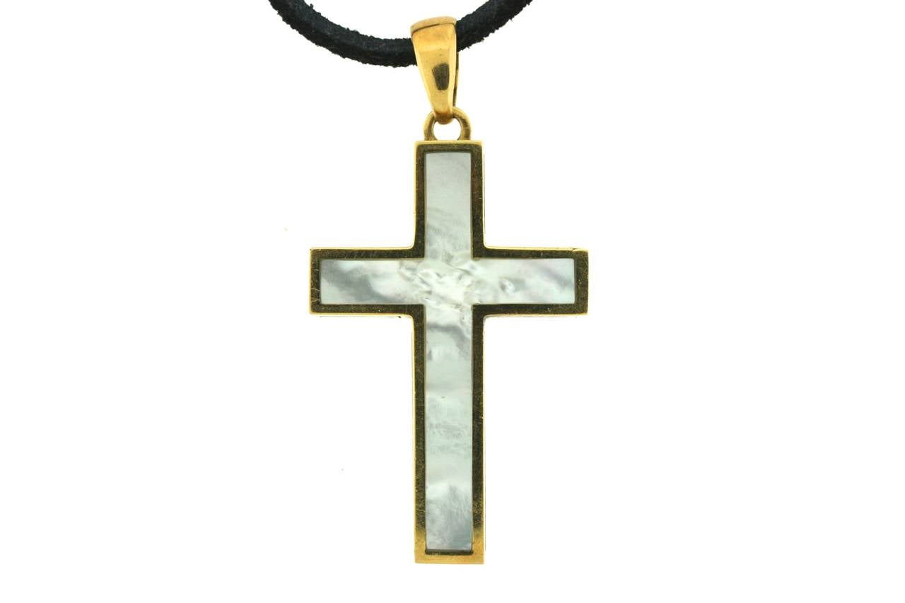Bulgari 18k gold cross designed in a color block combination of mother-of-pearl, malachite and black onyx. Bulgari was extremely skillful in combining colorful hard stones to define and create style within a piece of jewelry so that the piece is
