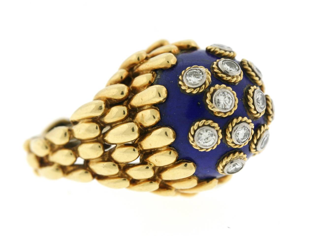David Webb 18k gold ring centering a spherical lapis stone set with thirteen diamonds in twisted gold and platinum bezel settings. Total approximate diamond weight is .65cts. The specific gold work in the setting and the technique of placing