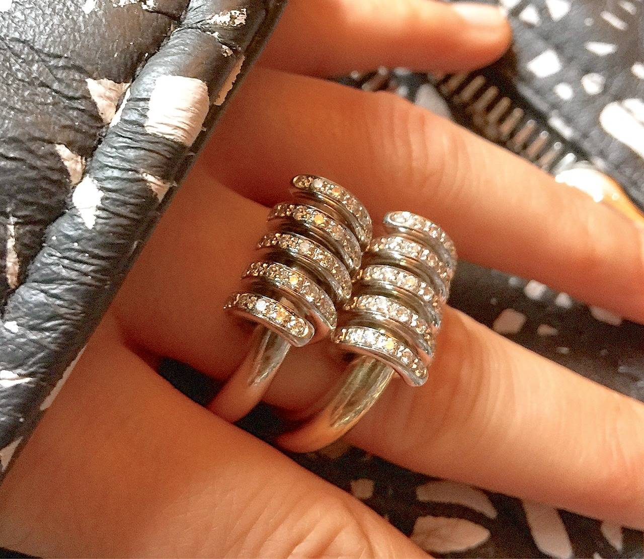 A pair of solid 18k yellow gold and white gold rings with diamond set coils around the top of the ring. Can be worn together or on separate hands or fingers. These rings have substantial weight which contributes to their industrial and masculine