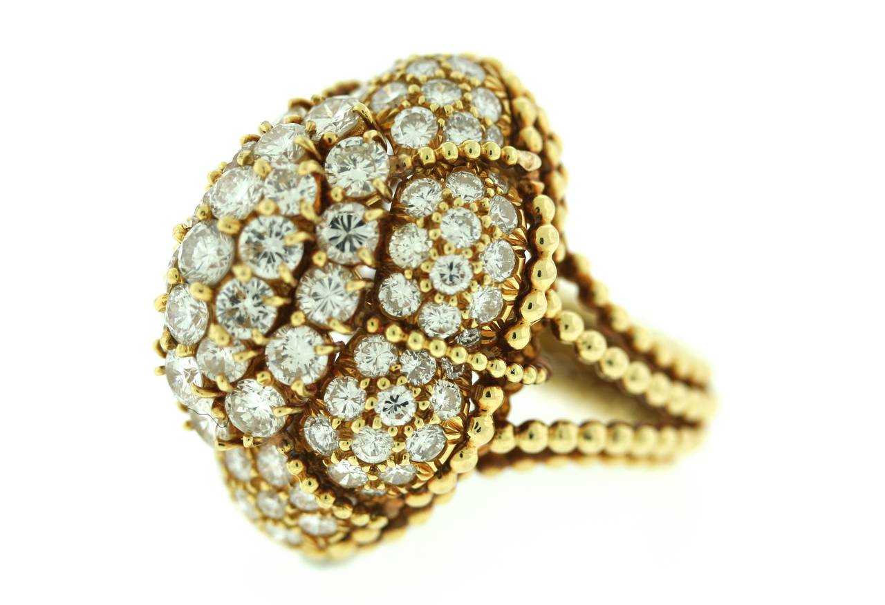 18k gold and diamond cocktail ring of an elaborate stepped setting with 17 diamonds on the surmount and 72 surrounding diamonds for an approximate total weight of 4carats. Delicate beaded gold work encircles the base, shank and body of the ring. A