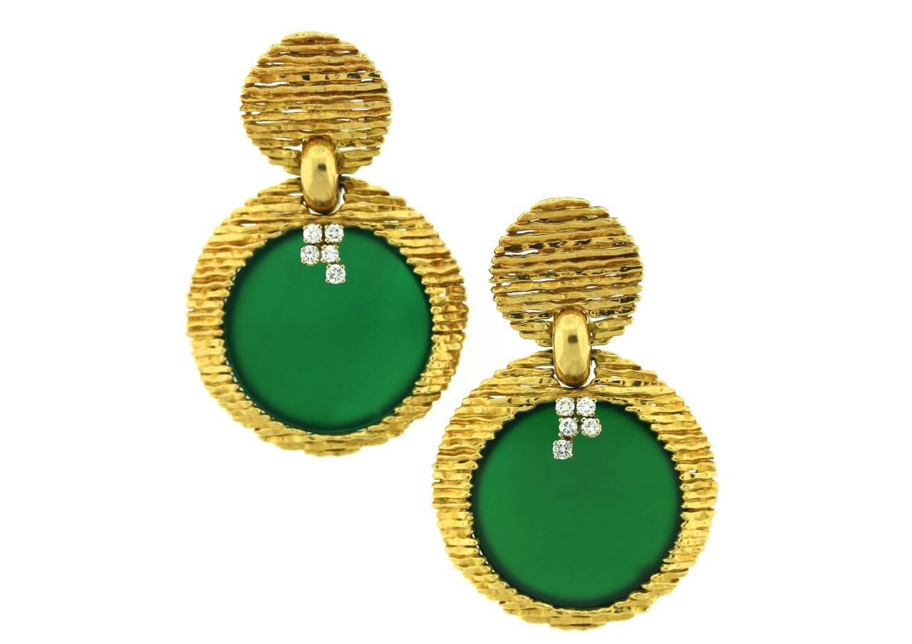 Van Cleef & Arpels Paris 18k horizontally striated gold ear pendants designed as a circular gold top suspending a larger circular gold bottom centering a hinged frame on the reverse side of the earring which opens to accommodate various stone discs