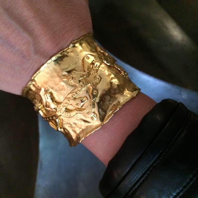 Iconic Jean Mahie: broad, hammered cuff bordered by a raised ridge of 22k gold. Features abstract, sculptural 