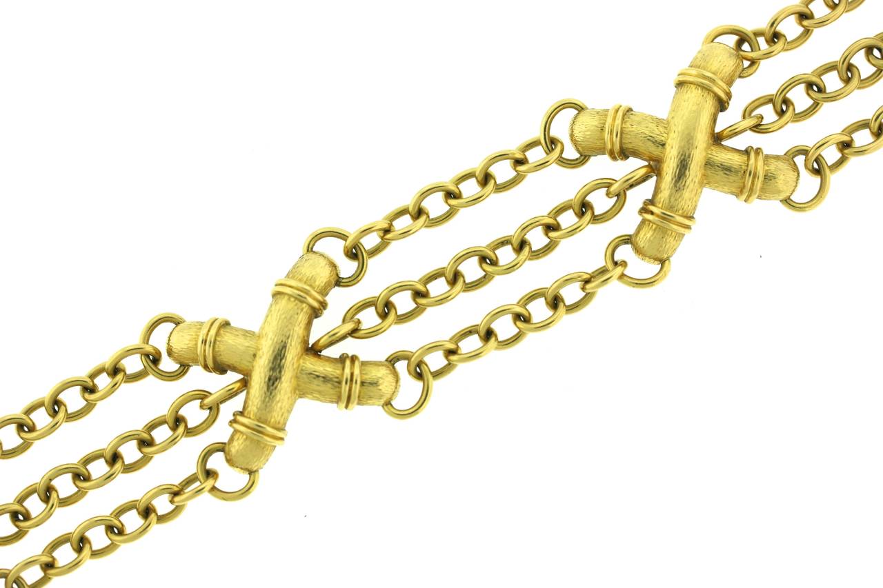 Schlumberger for Tiffany & Co 18k gold bracelet of a triple width chain link with three textured gold stylized 