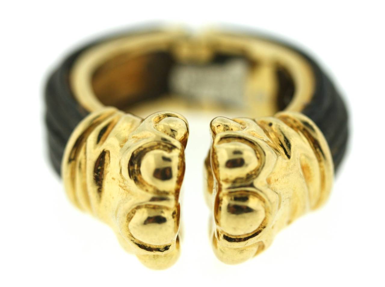This whimsical design by Donald Claflin for Tiffany & Co is a fun and stylish piece. Mounted in 18k gold this elephant hair ring has two center elephant feet which part slightly when placed on the finger to accommodate a slight variation in finger