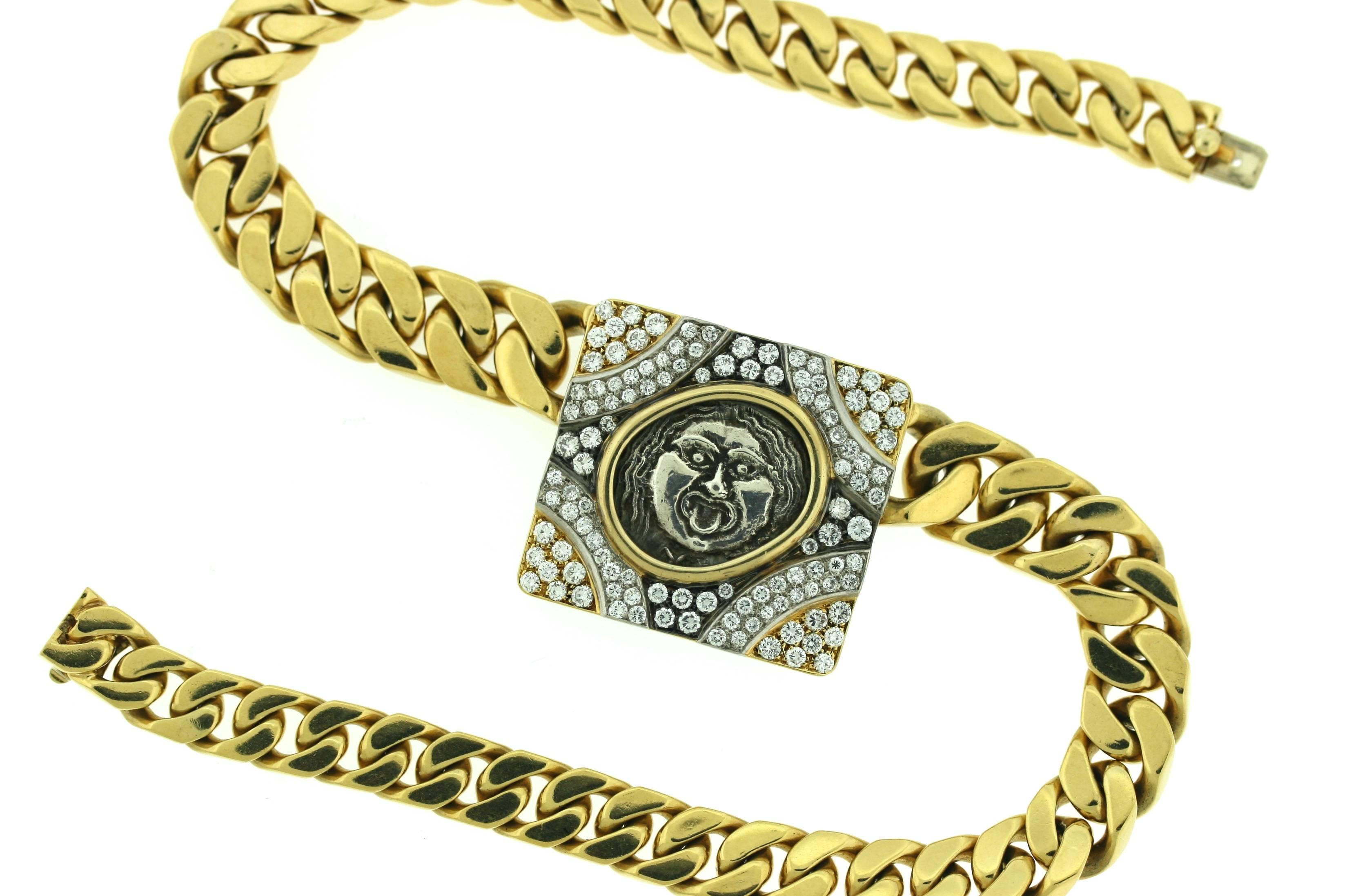 Bulgari 18k gold necklace designed as a thick solid curb link chain centering an ancient coin set within a square frame of diamonds in yellow, white and blackened gold. Engraving on the reverse side of the coin reads 
