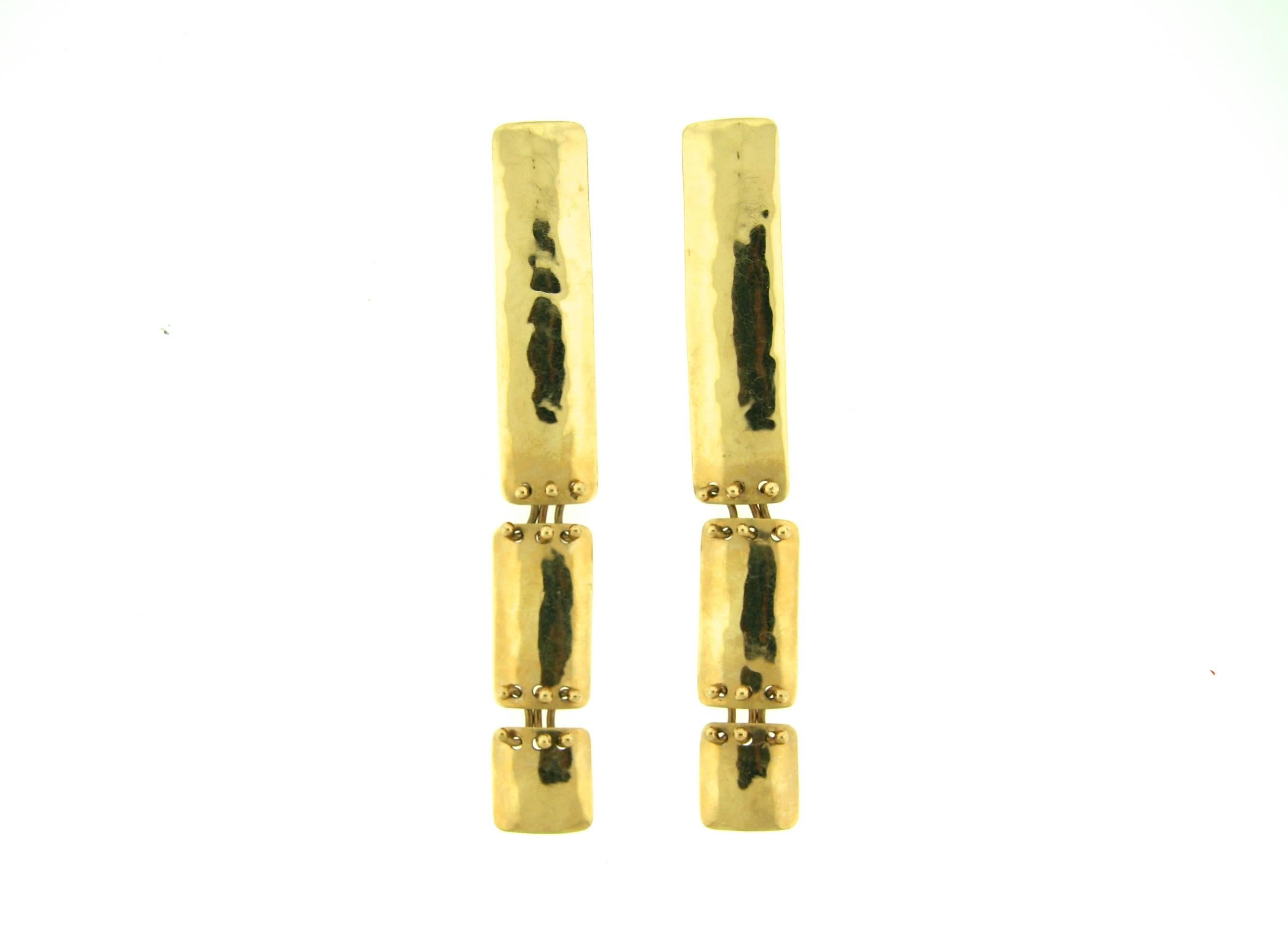 These artistic hammered 14k gold earrings have a modern artistic flair in addition to being lightweight, comfortable and articulated for swing and movement. They are 3.75