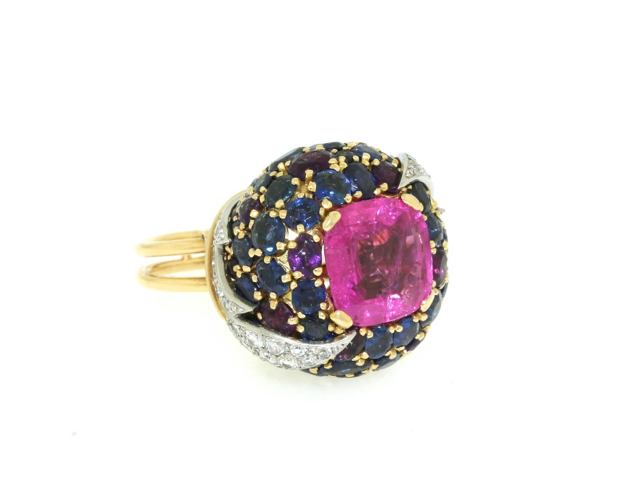 Schlumberger Paris 18k gold platinum and diamond foliate motif ring with a bombe cluster of sapphires and amethysts centering a certified natural 6.91 cushion-cut pink sapphire. Ring measures 1