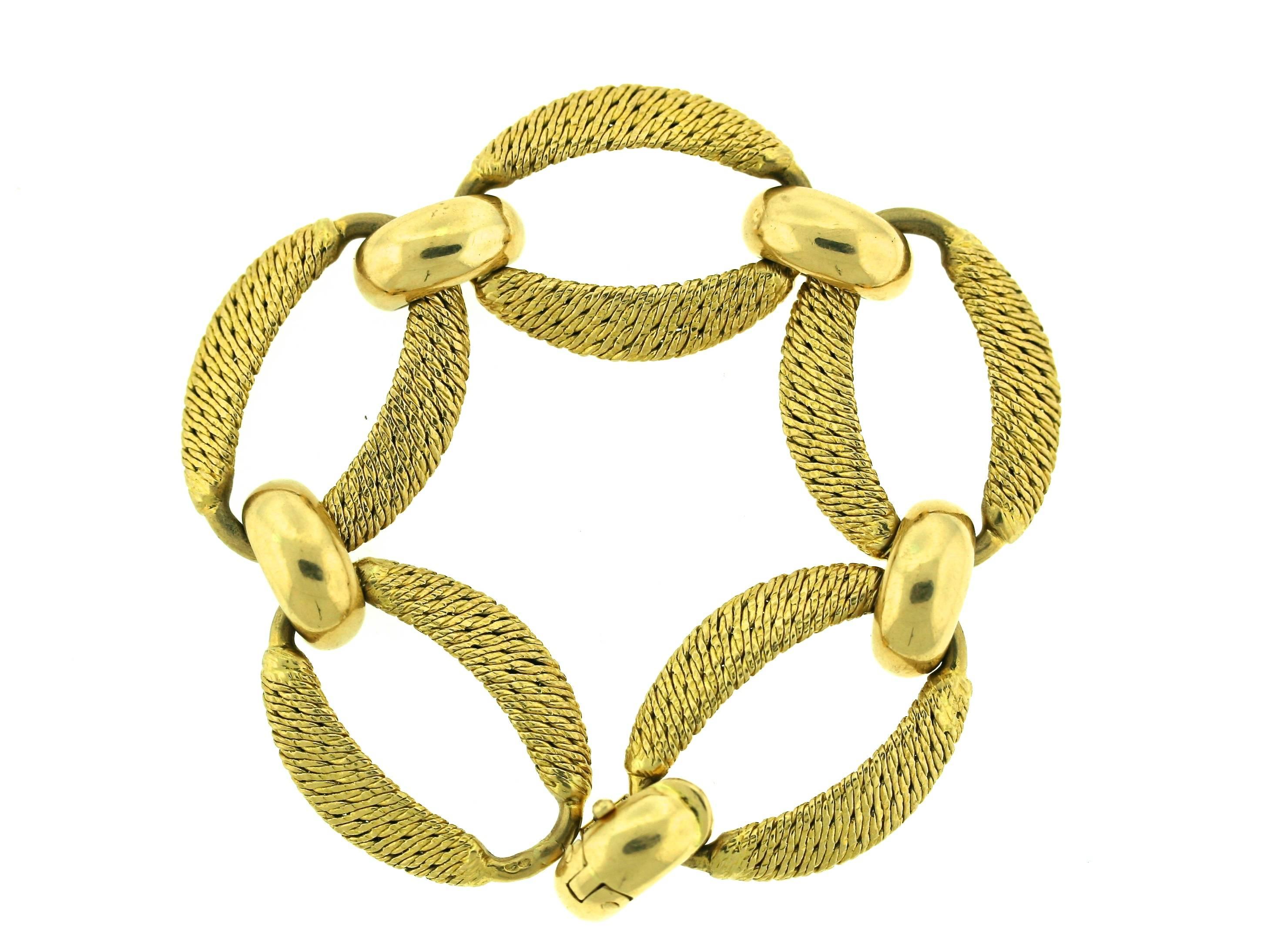 Mellerio dits Meller 18k woven gold open oval link bracelet joined by polished gold rounded top links. The technique of producing this type of a woven gold effect was popularized by several master French workshops in the 1970s such as Georges