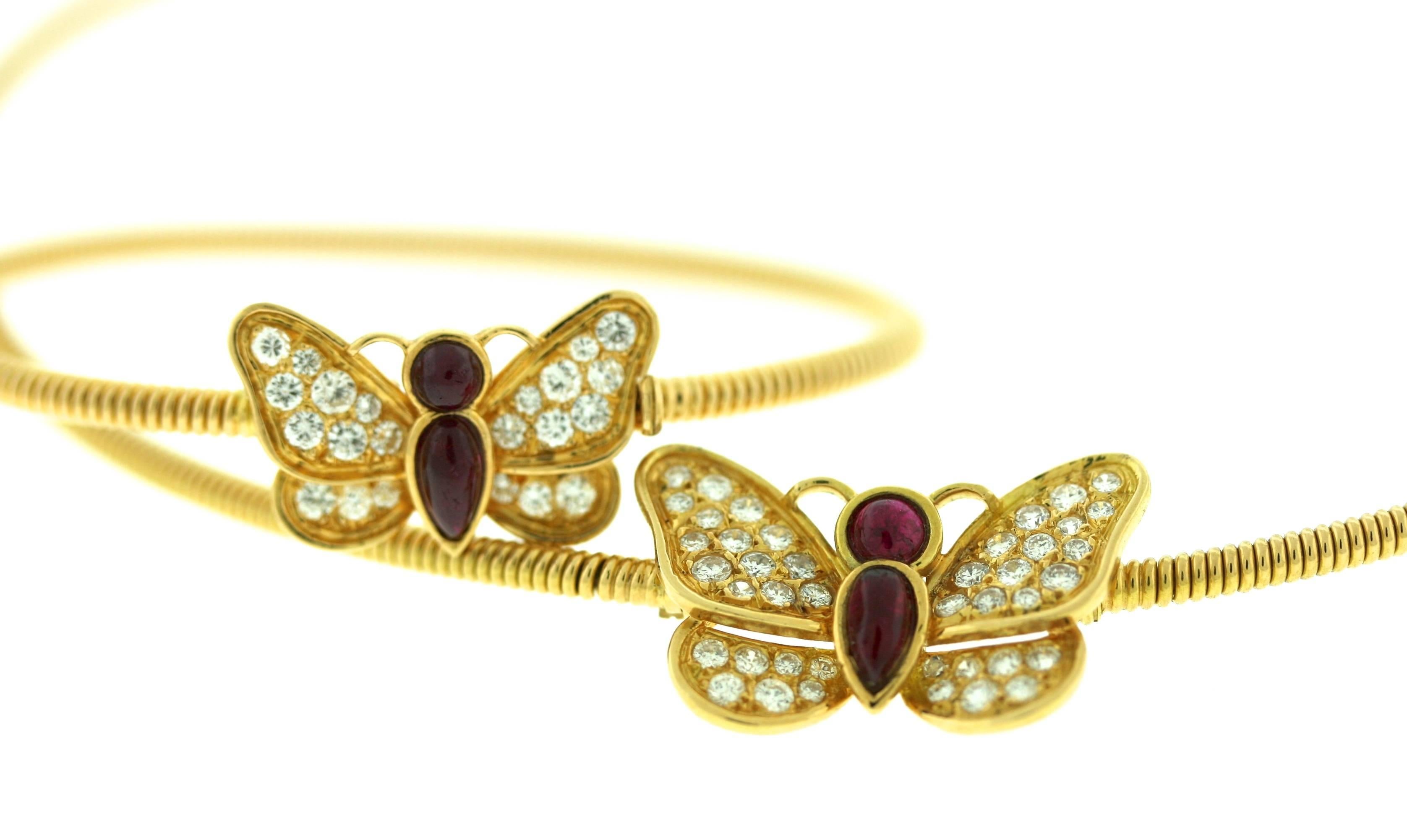 Cartier Paris 18kt gold choker and bracelet suite set with diamonds and cabochon rubies in a charming butterly motif. Both bracelet and choker are made from finely coiled gold each centering a butterfly. Internal circumference of choker is 14.5