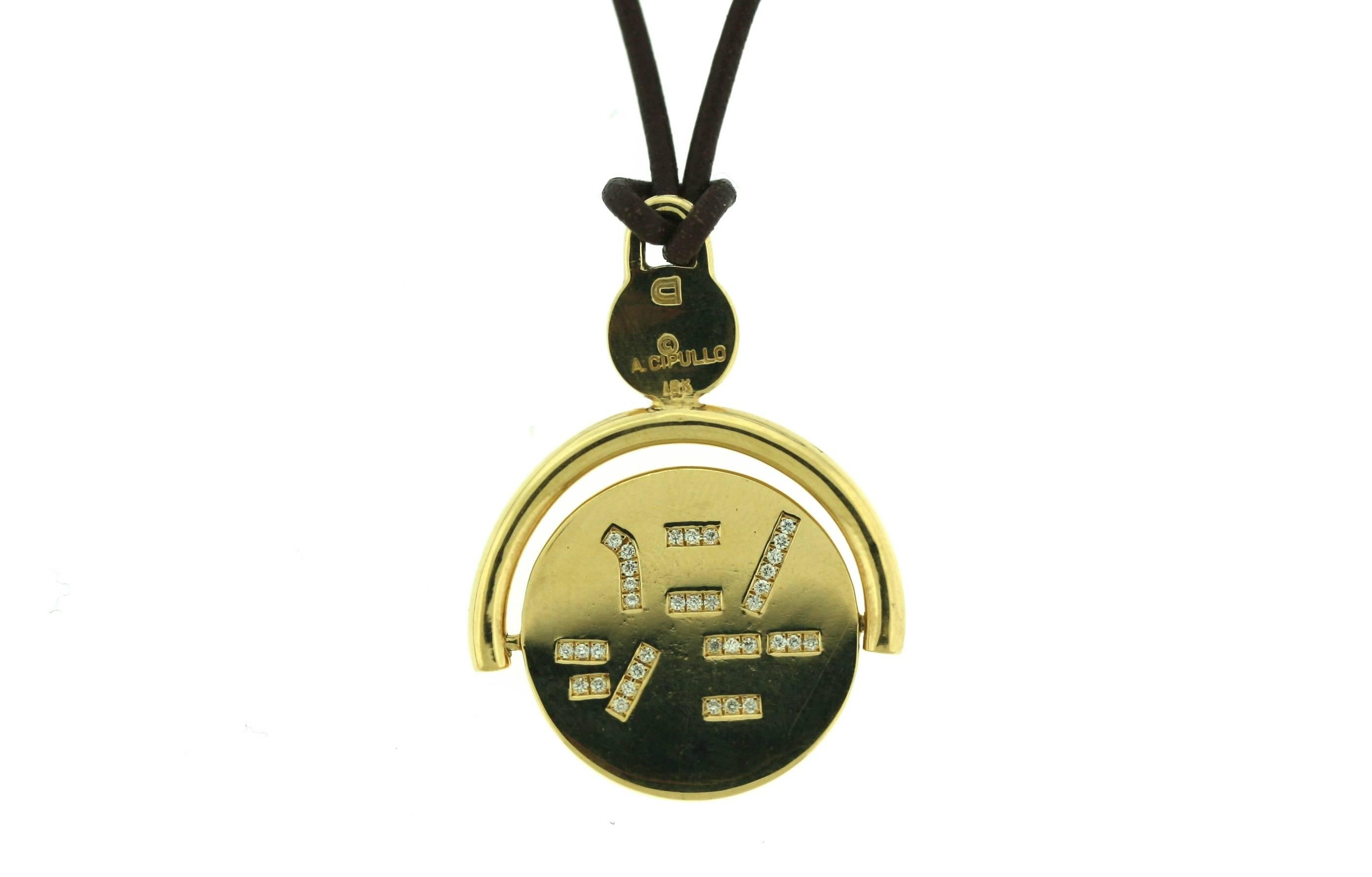 Aldo Cipullo 18k gold and spinning pendant with one half of the phrase set in diamonds on the front and the other half in diamonds on the reverse. When the pendant spins the complete phrase 