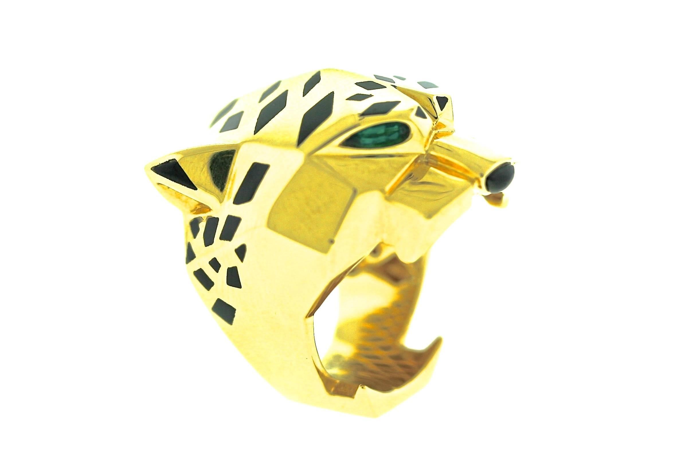 Iconic Cartier Panthere collection ring in 18k gold, enamel and black onyx with faceted peridot eyes. Size 7.5.  1