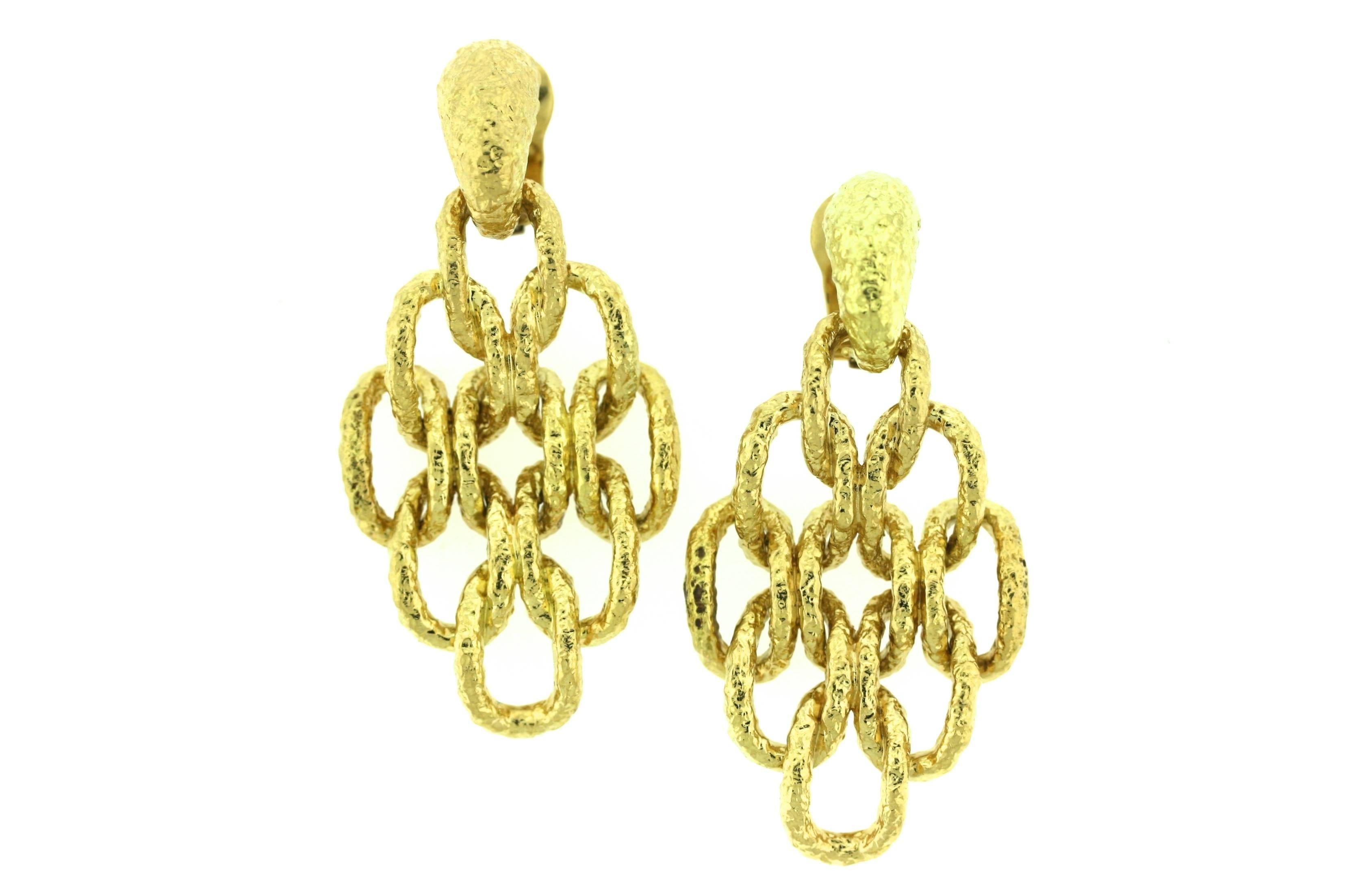 Van Cleef & Arpels Paris 18k textured gold ear clips designed as a hammered gold top suspending nine articulated open oval links. A stylish and versatile 1970s day-to-night earring. 2.5