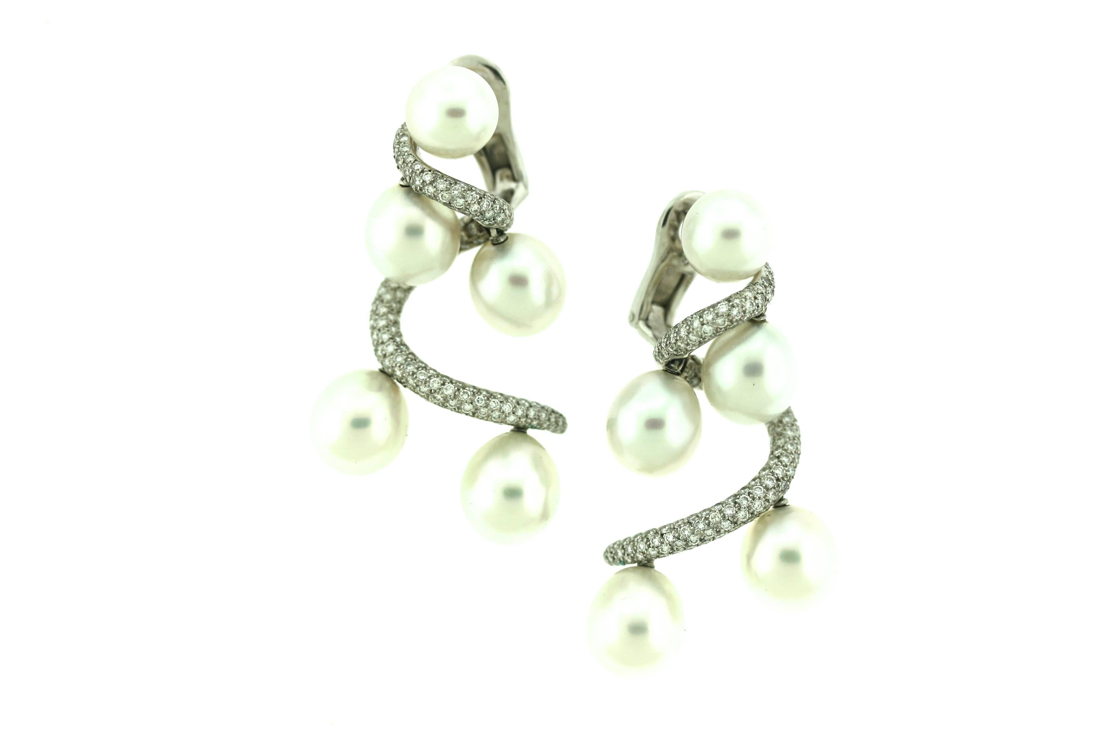 Chanel 18k white gold ear clips designed as a diamond pave-set cascading helix suspending dangling South Sea pearls. These spectacular earrings were created in 1997 to commemorate the opening of the Chanel Boutique on the famed Place Vendome in