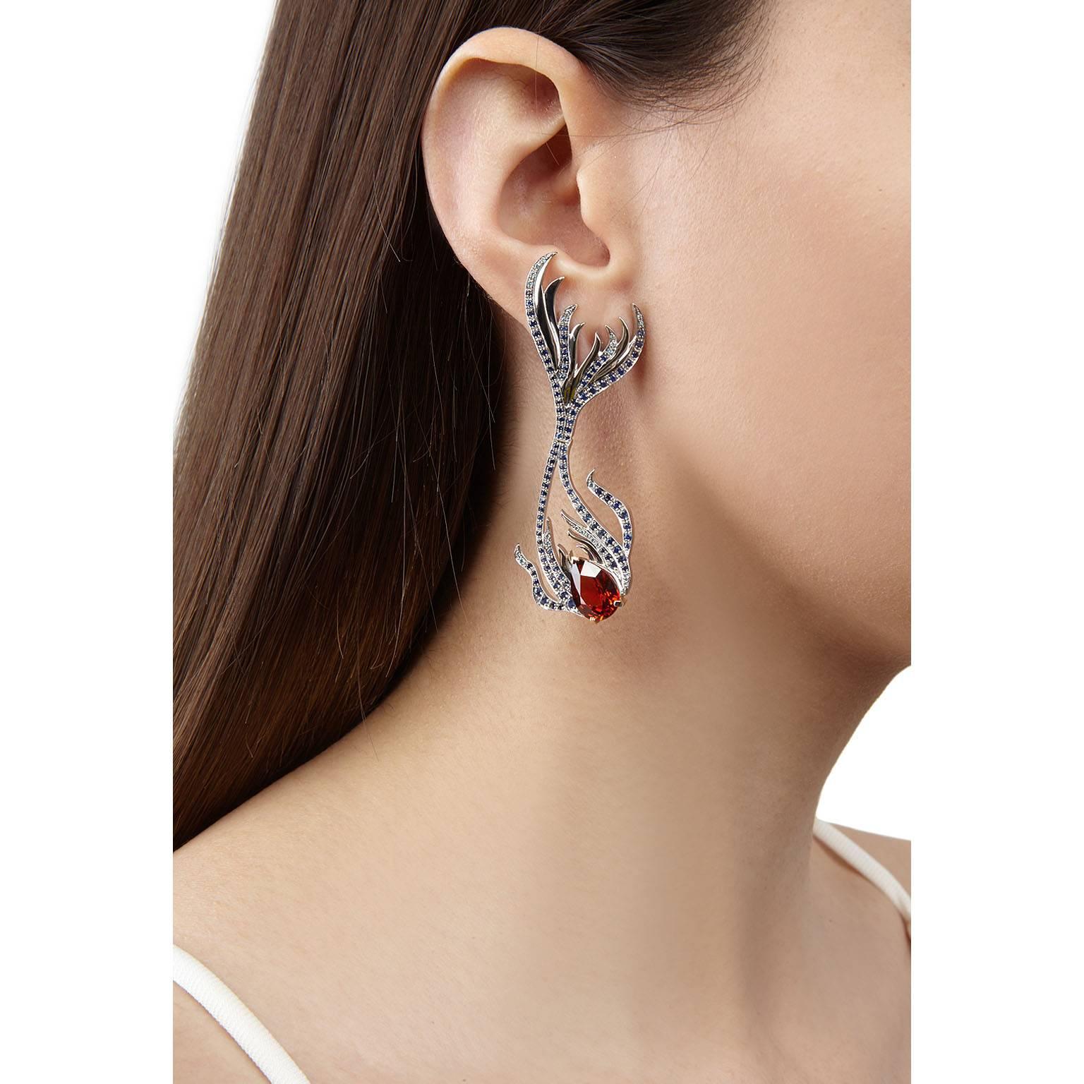 These spectacular Sirena earrings are one of Milena Kovanovic's most head-turning creations to date. The super sized exotic fishes are crafted in sinuous white gold and hinged at their centre to provide a subtle movement when worn. Pavé set with a