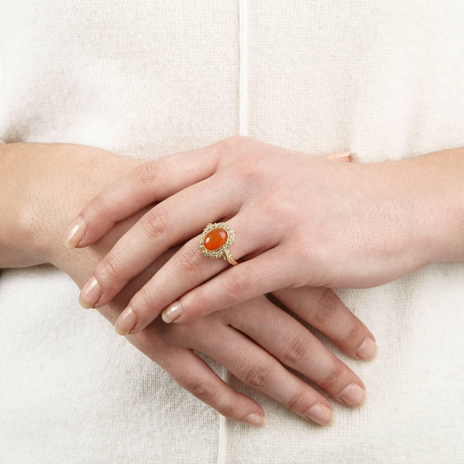 The beautiful La Belle ring features a vibrant orange carnelian stone at its centre, surrounded by a halo of seed pearls. All encrusted in rose gold plated silver atop a hammered band. 

Ring size: UK L / US 5.75 / EU 11.25
Stone measures: 12 x