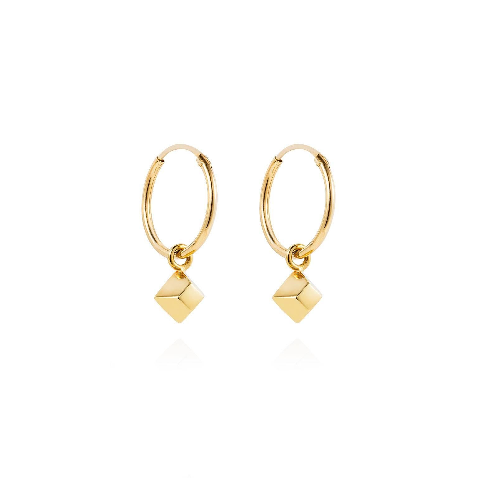 Wear alone or as part of a cool layered look if you have multiple piercings. These delicate mini pyramid hoop earrings open with an integral hinge at the top of the hoop, and close to create a sleek circular earring.

Crafted in 18k yellow gold they