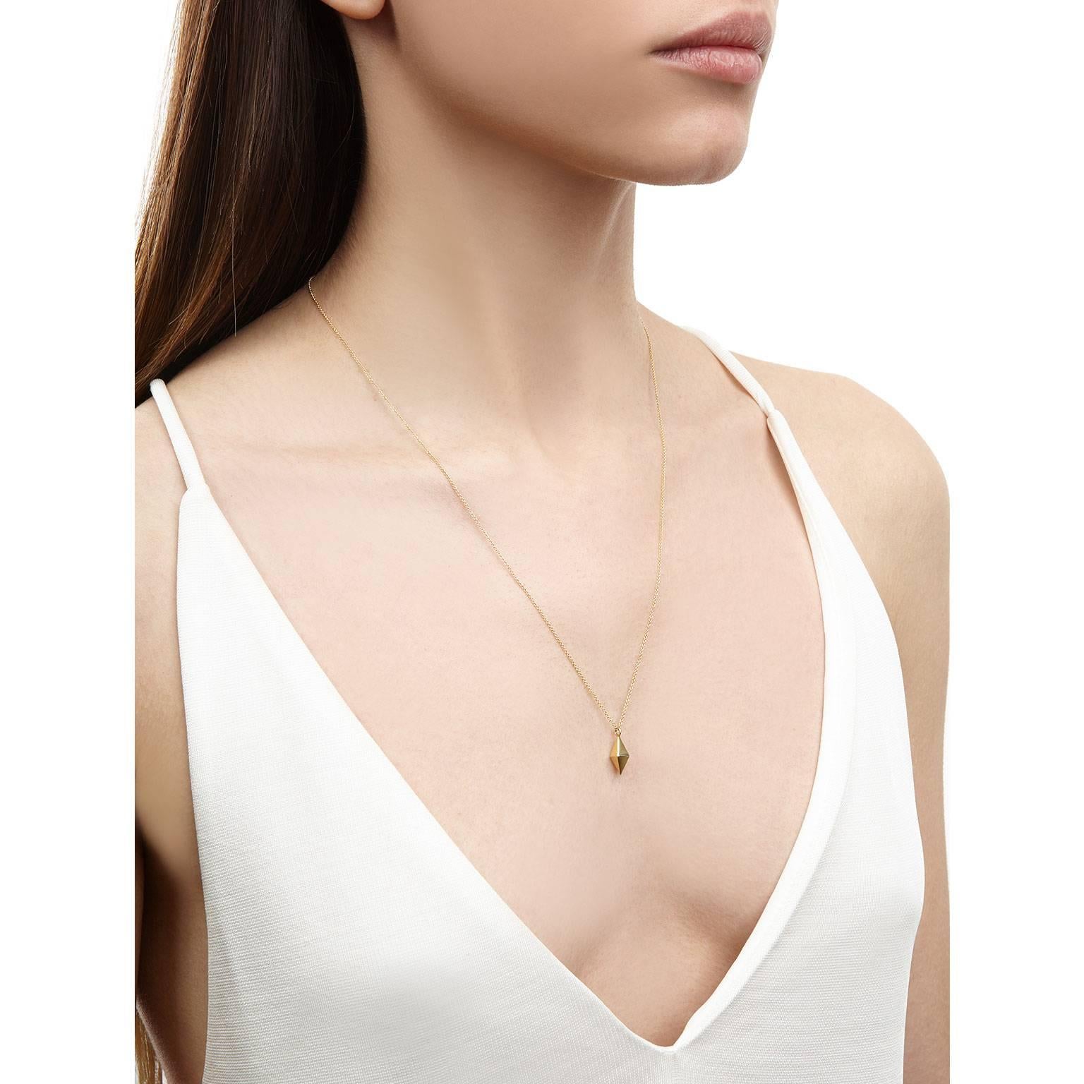 This gold octahedral double pyramid necklace brings a clean and minimal aesthetic to your everyday look. The pendant is suspended on a fine trace chain featuring a shackle catch fastening. 
Wear it alone or layered with other necklaces for a chic