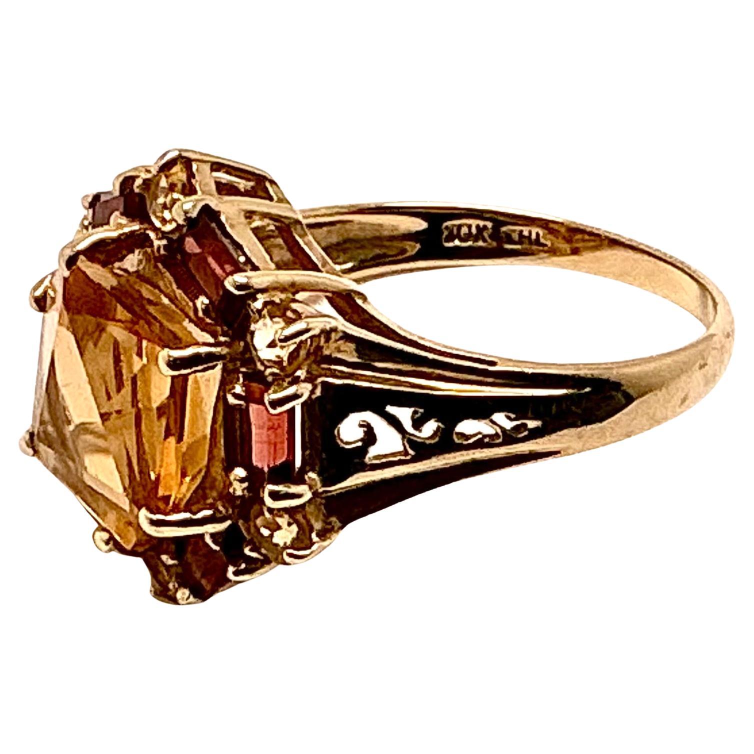 10k Citrine ring with baguettes, 4.14 Grams TW. The dimension of the round citrine is approximately 11mm. Approximately 7 carats. Marked 10k. Approximate size 6.5.
