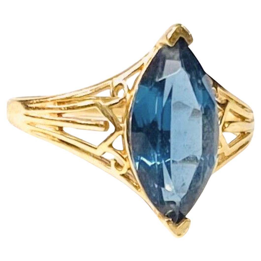 14k yellow gold marquise blue topaz ring, 3.10 Grams TW. The dimensions are approximately 14 mm x 7 mm. Approximately 3 carats. Marked 14k. Approximate size 7.5.
