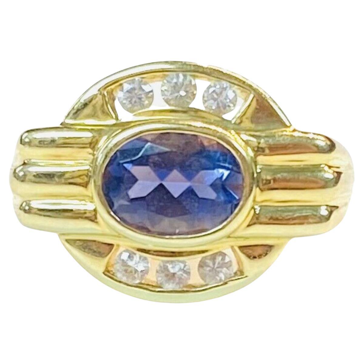 14k yellow gold purple tanzanite and diamond ring, 6.01 Grams TW. The dimensions of the oval tanzanite are approximately 8 mm x 5.5 mm. Approximately 1 carat. Marked 14k. Approximate size 7.