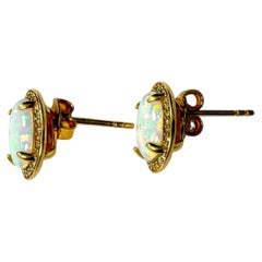 10 Karat Yellow Gold with Oval Opal and Diamond Stud Earrings A Pair