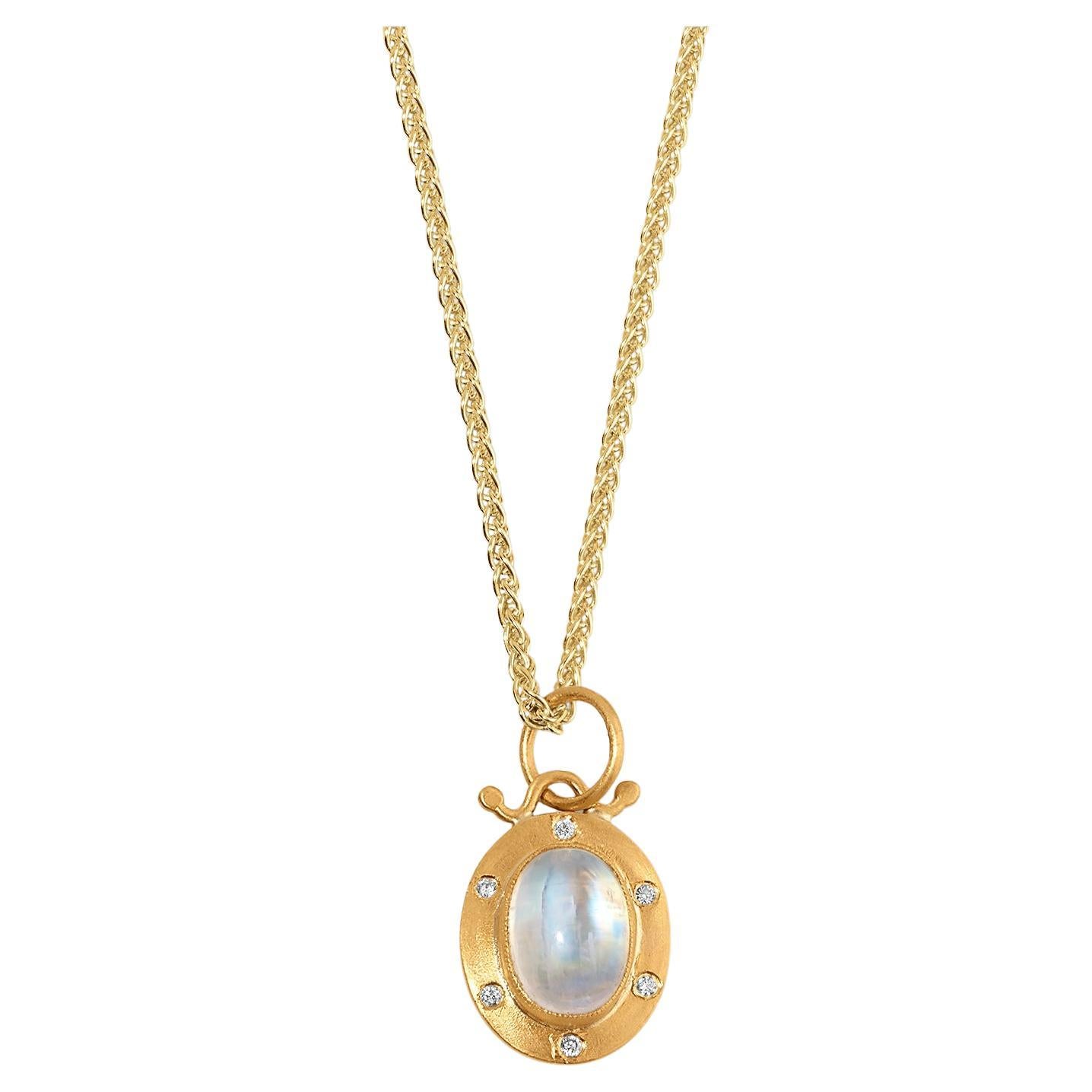 Oval Moonstone Charm Pendant Necklace with Diamonds, 24kt Gold and Silver by Prehistoric Works of Istanbul, Turkey. Opal - 2.60cts, Diamonds - 0.06cts. This stunning opal is framed in 24kt gold with six diamonds.  This piece is sure to make a