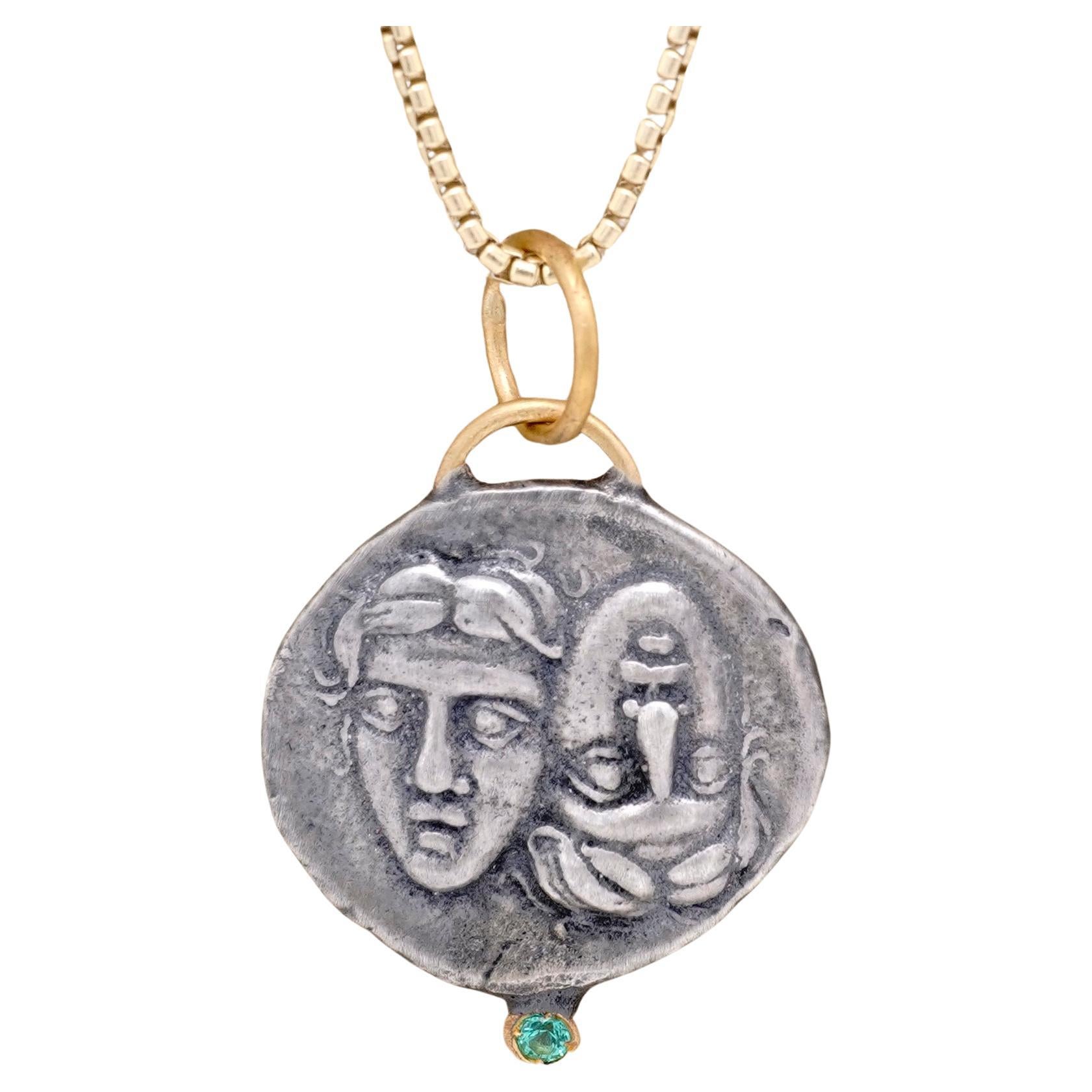 Astros Coin Charm Amulet Pendant Necklace with Emerald, 24kt Gold and Silver by Prehistoric Works of Istanbul, Turkey. Emerald - 0.03cts. These coin amulets pair well alone or with other coin pendants or with miniature pendants. Measures: 18.7mm x